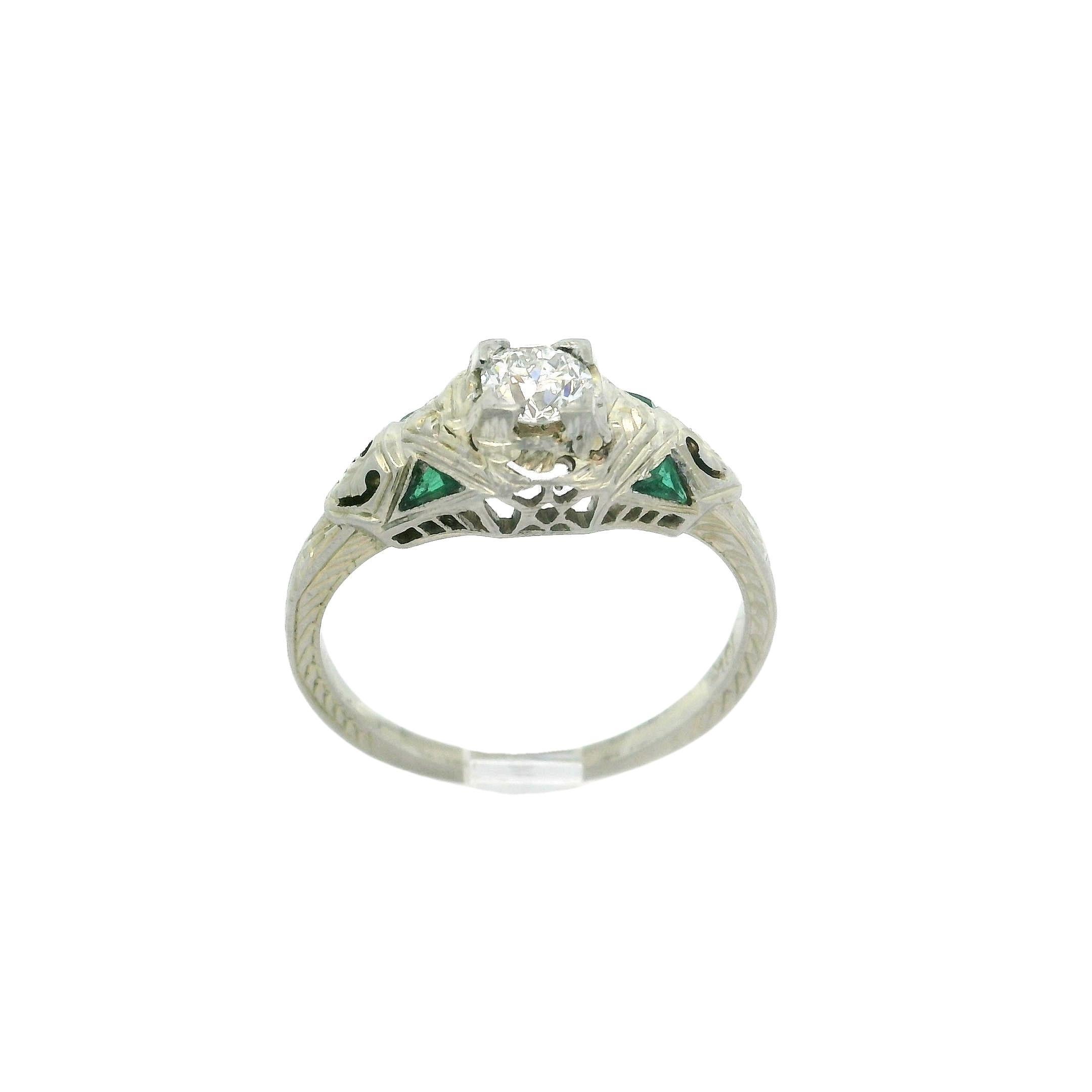 –Stone(s)–
(1) Natural Genuine Diamond - Old European Cut - Prong Set - G Color - VS1 Clarity - 0.29ct (approx.)
(4) Synthetic Emeralds - Custom Cut - Milgrain Bezel Set - Green Color

Material: Solid 18k White Gold
Weight: 2.73 Grams
Ring Size: 6.0