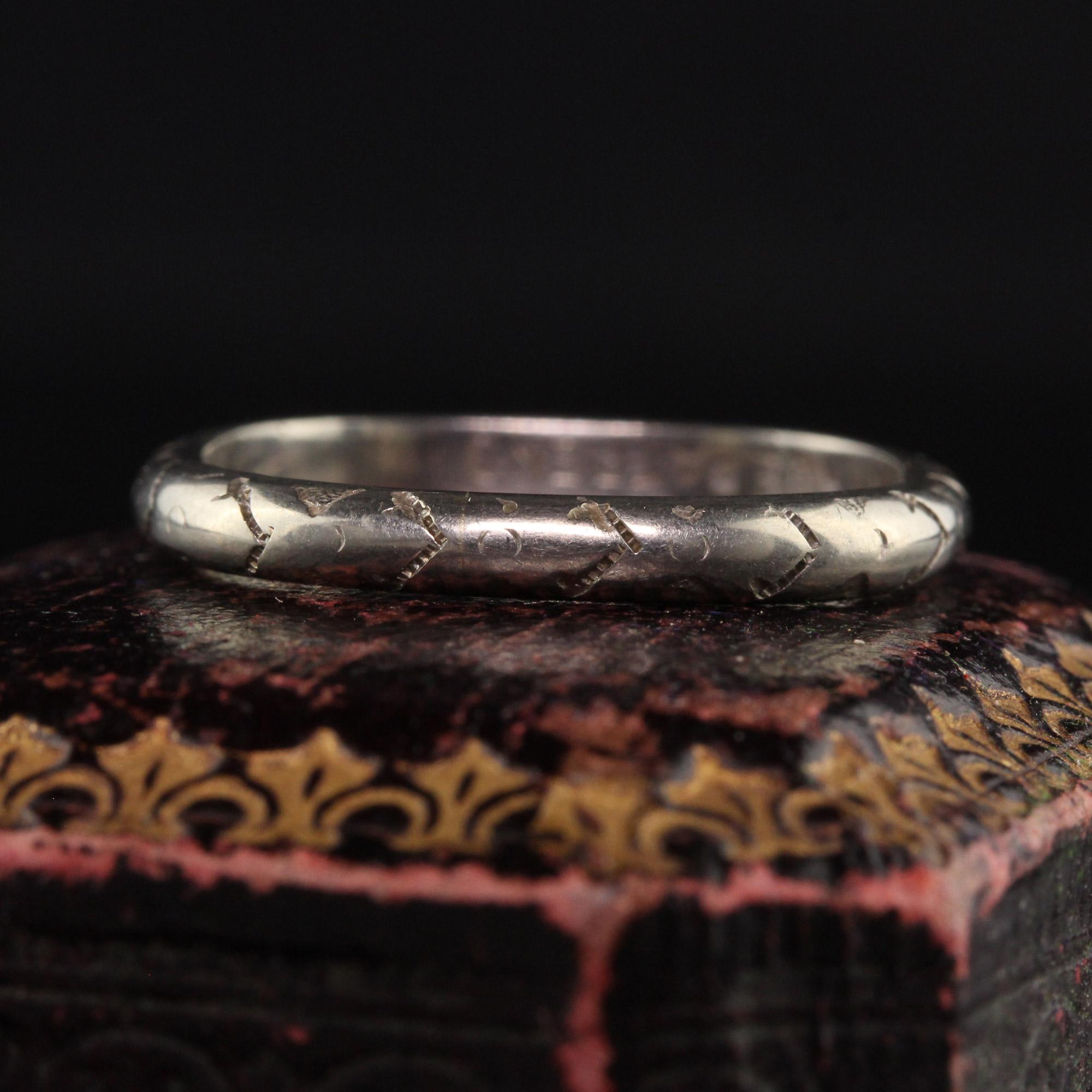 Beautiful Antique Art Deco 18K White Gold Engraved Squared Wedding Band. This gorgeous wedding band is crafted in 18k white gold. The band has an interesting shape that is a rounded square shape. It has engravings going around the entire ring and is