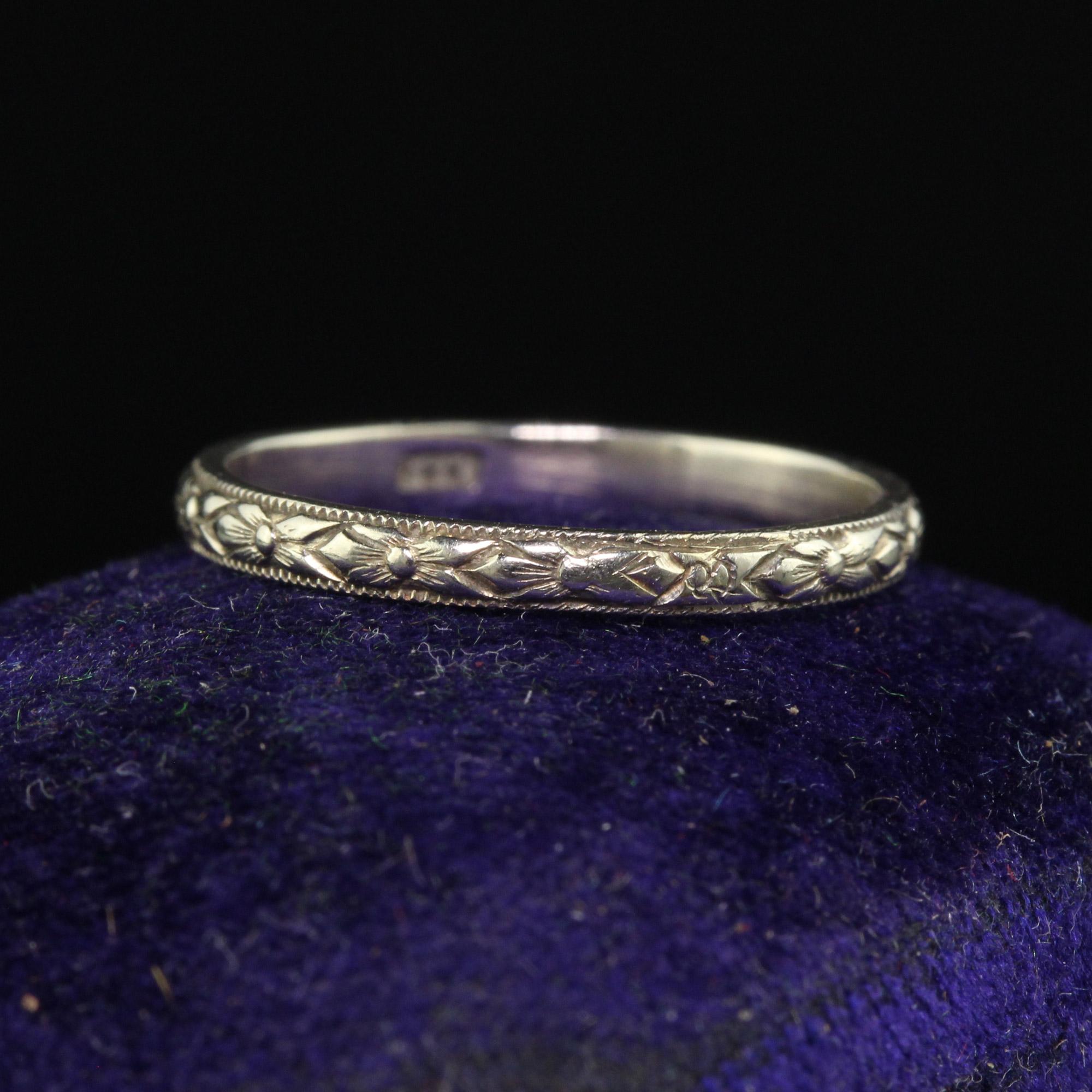 Beautiful Antique Art Deco 18K White Gold Engraved Wedding Band - Size 5 1/2. This gorgeous wedding band is crafted in white gold. The ring has deep engravings going around the entire ring and sits low on the finger. It can be stacked with other