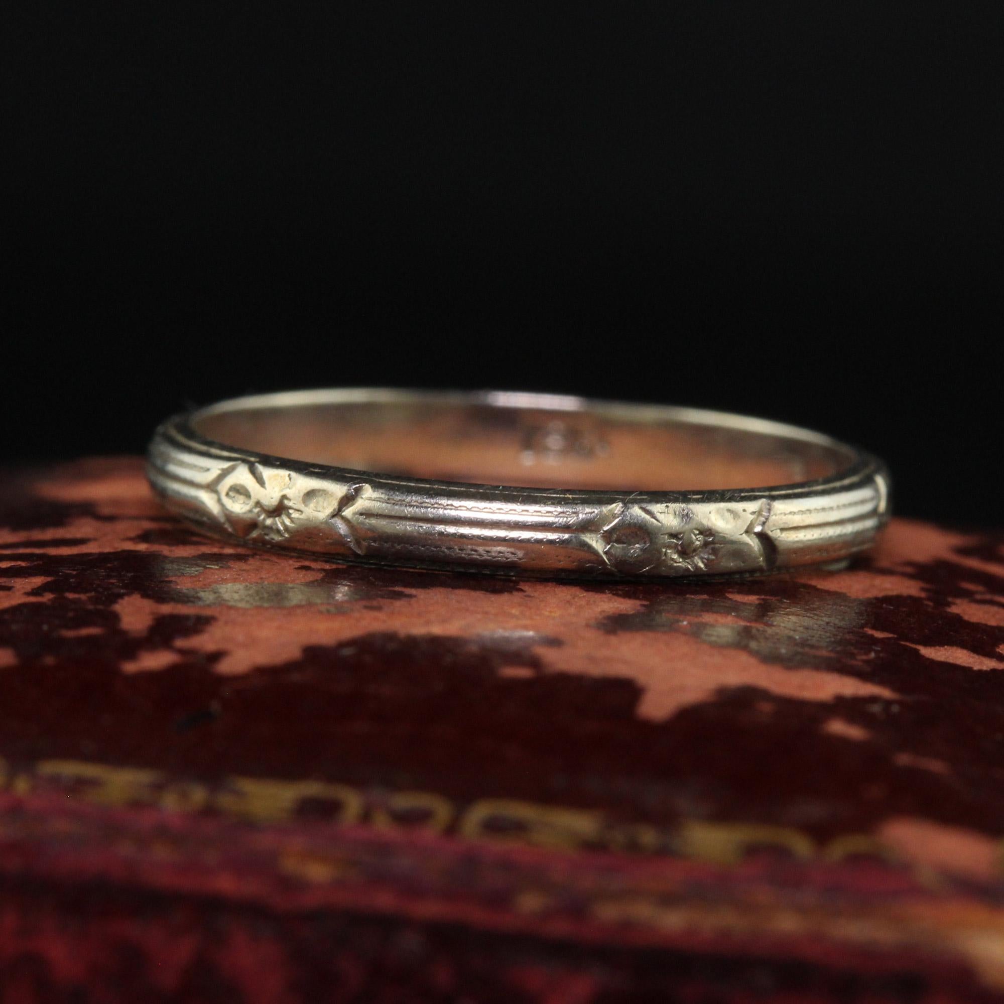 Beautiful Antique Art Deco 18K White Gold Engraved Wedding Band - Size 5 1/2. This incredible wedding band is crafted in 18k white gold. This beautiful band has engravings going around the entire ring and sits low on the finger. The ring is in great