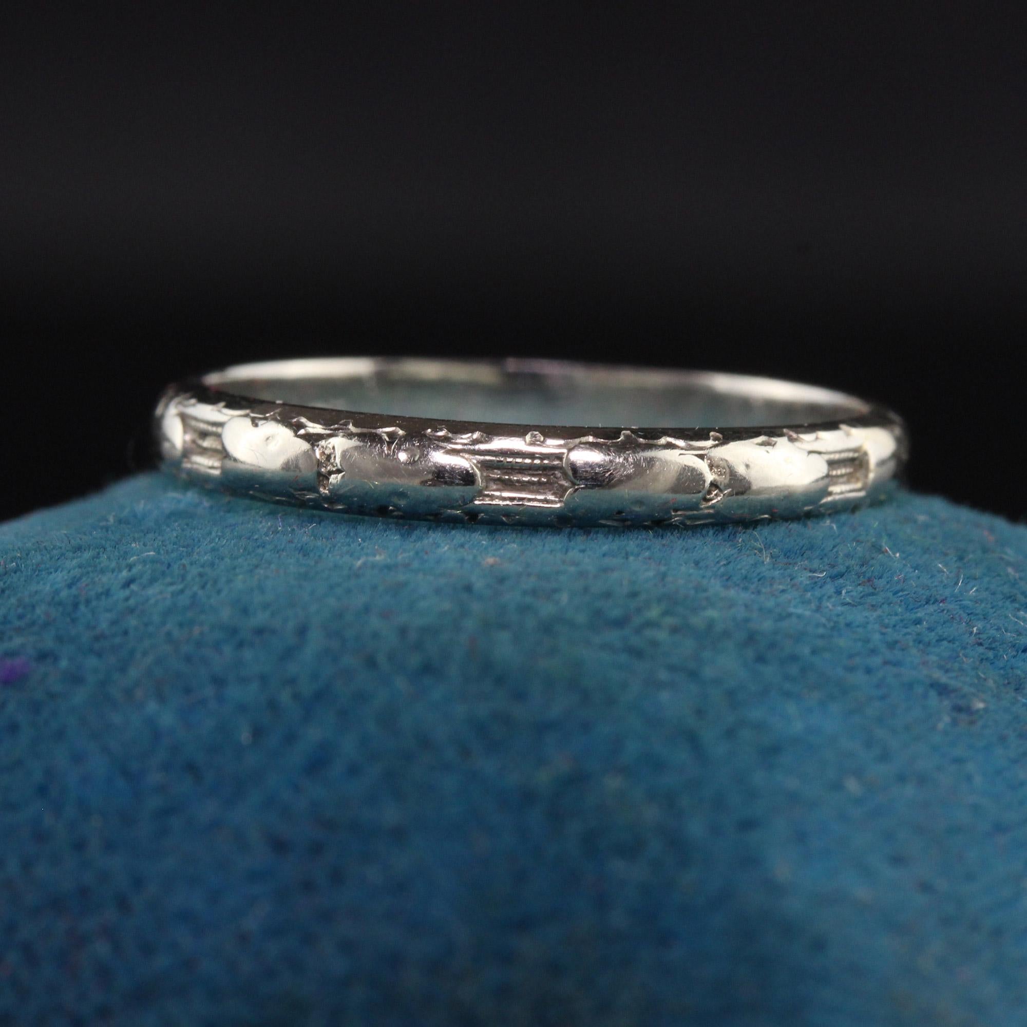 Beautiful Antique Art Deco 18K White Gold Engraved Wedding Band - Size 6. This beautiful wedding band is crafted in 18k white gold. The ring has an interesting design going around the ring with one part of it that aooears to have been sized. It is