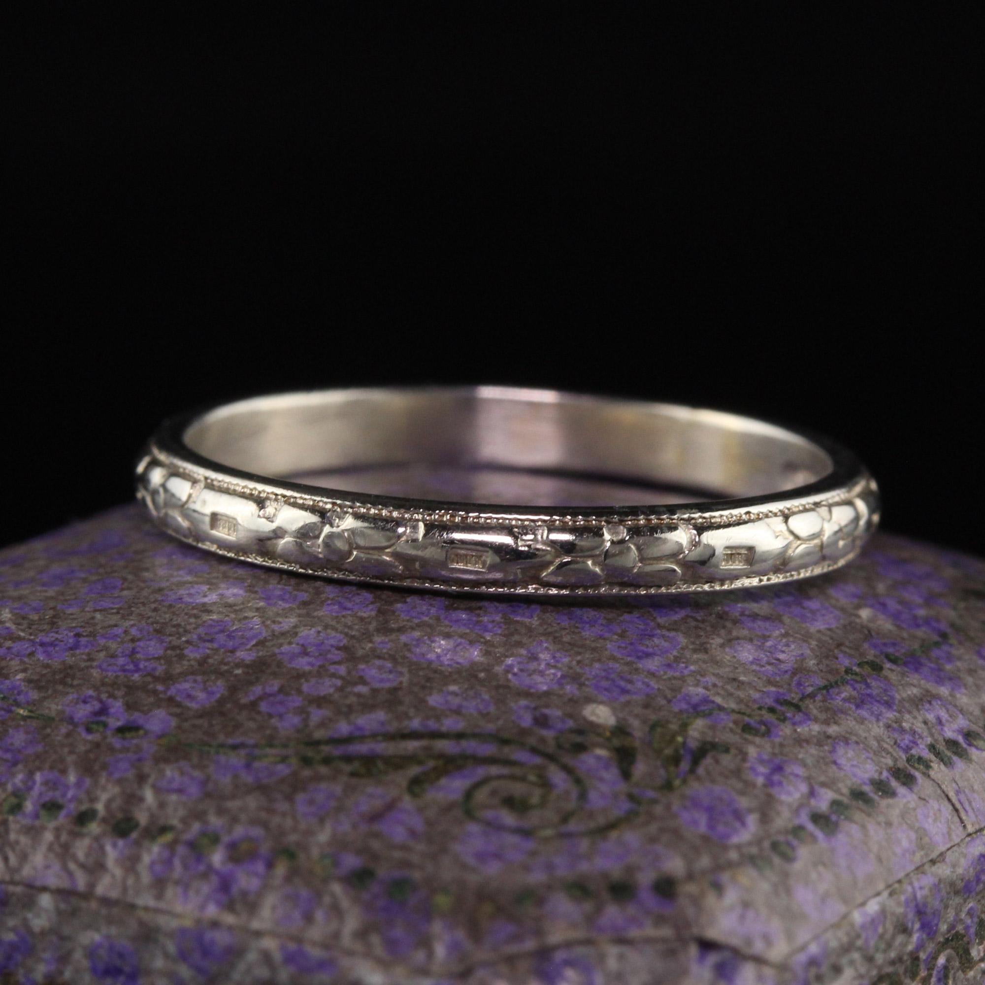 Beautiful Antique Art Deco 18K White Gold Engraved Wedding Band - Size 7 3/4. This beautiful band is crafted in 18k white gold. The band is engraved around most of the band and one part has been sized before and has a smooth spot from where it was