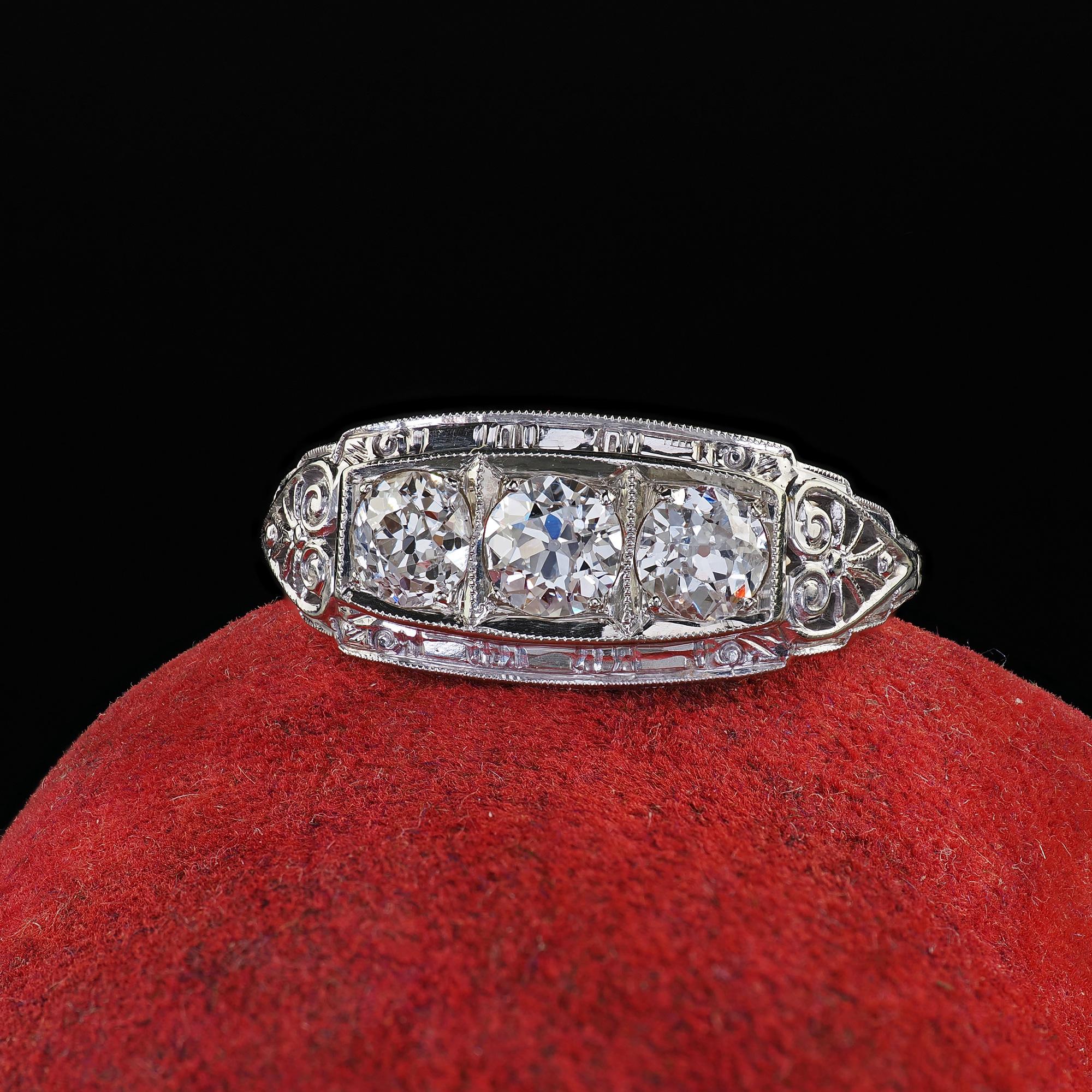 Beautiful Antique Art Deco 18K White Gold Filigree Old European Diamond Three Stone Ring. This amazing Art Deco filigree old European diamond three stone ring is crafted in 18k white gold. This gorgeous ring features three old European cut diamonds