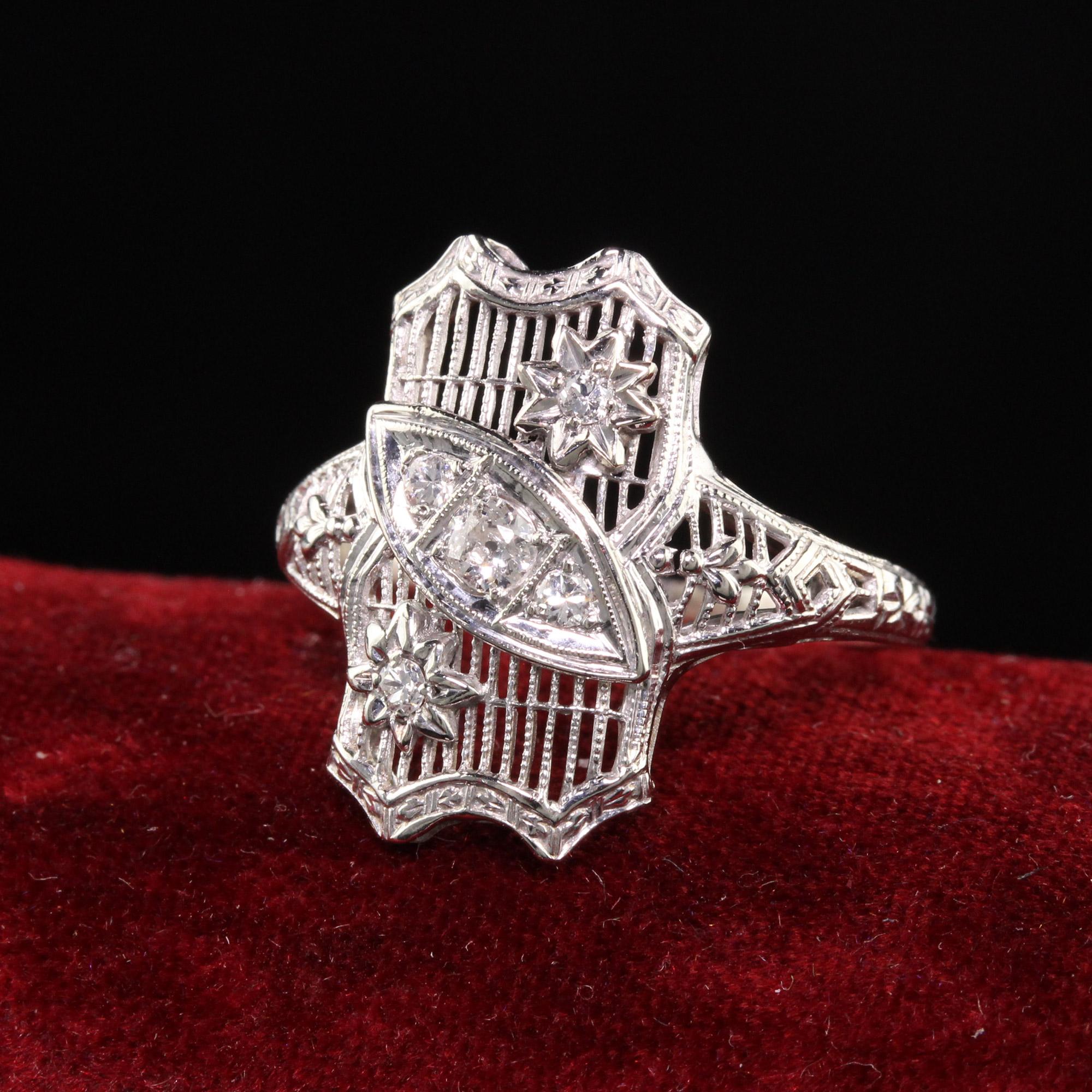 Beautiful Antique Art Deco 18K White Gold Old European Diamond Filigree Ring. This gorgeous ring is in pristine condition and has beautiful filigree work on the top of the ring. It has old european cut diamonds set in an interesting pattern.

Item