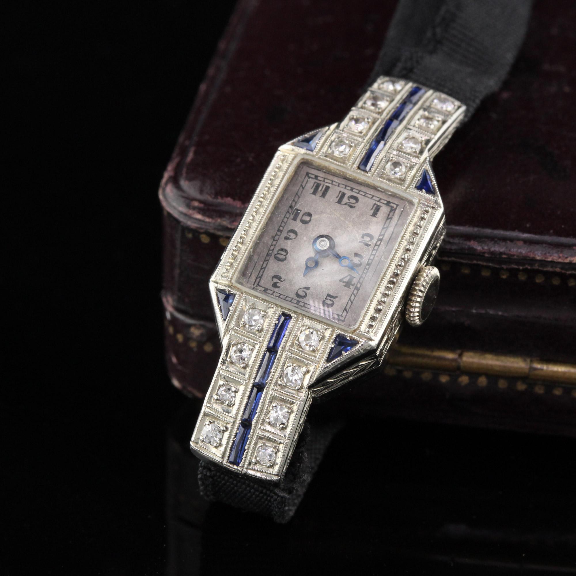 Stunning synthetic sapphire and diamond watch with adjustable fabric band.

Metal: 18K White Gold

Weight: 10.6 Grams

Diamond Weight: Approximately 0.30 cts

Diamond Color: H

Diamond Clarity: SI1

Measurements: Face measures 34.95 x 15.41 mm. Band