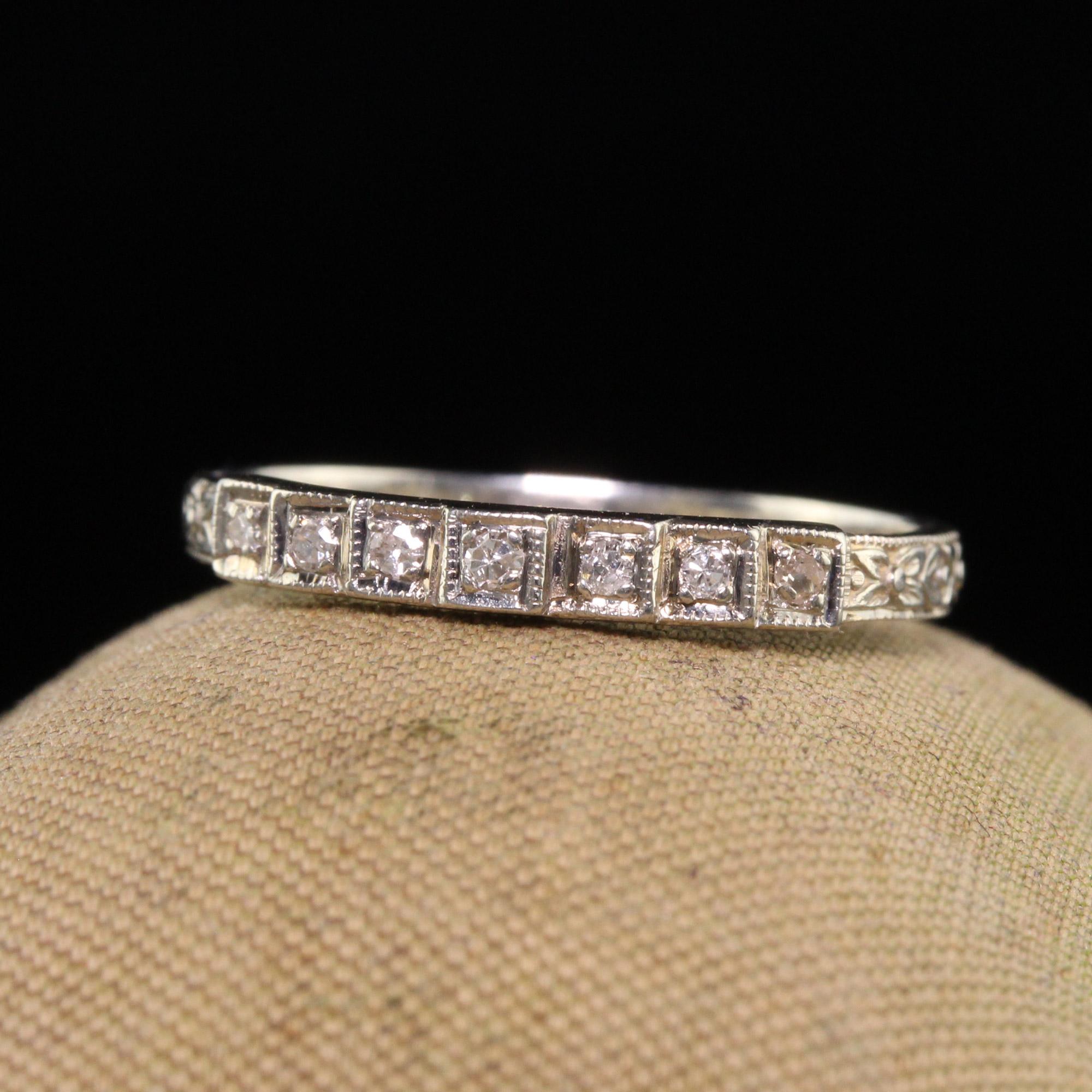 Beautiful Antique Art Deco 18K White Gold Single Cut Diamond Engraved Wedding Band. This beautiful wedding band is crafted in 18k white gold. The band features seven single cut diamonds in an engraved Art Deco wedding band mounting. The ring is in