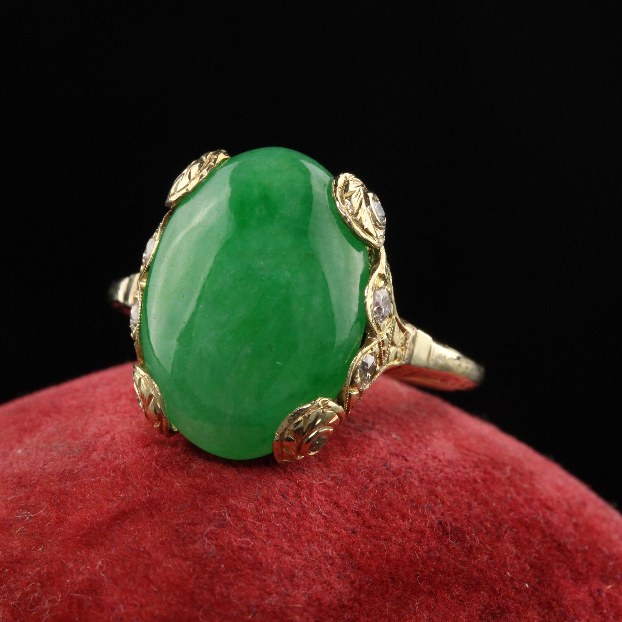 Beautiful Antique Art Deco 18K Yellow Gold Cabochon Jade and Old European Diamond Ring. This incredible ring has a large jade in the center of an engraved ring with old european cut diamonds set on the mounting.

Item #R0989

Metal: 18K Yellow