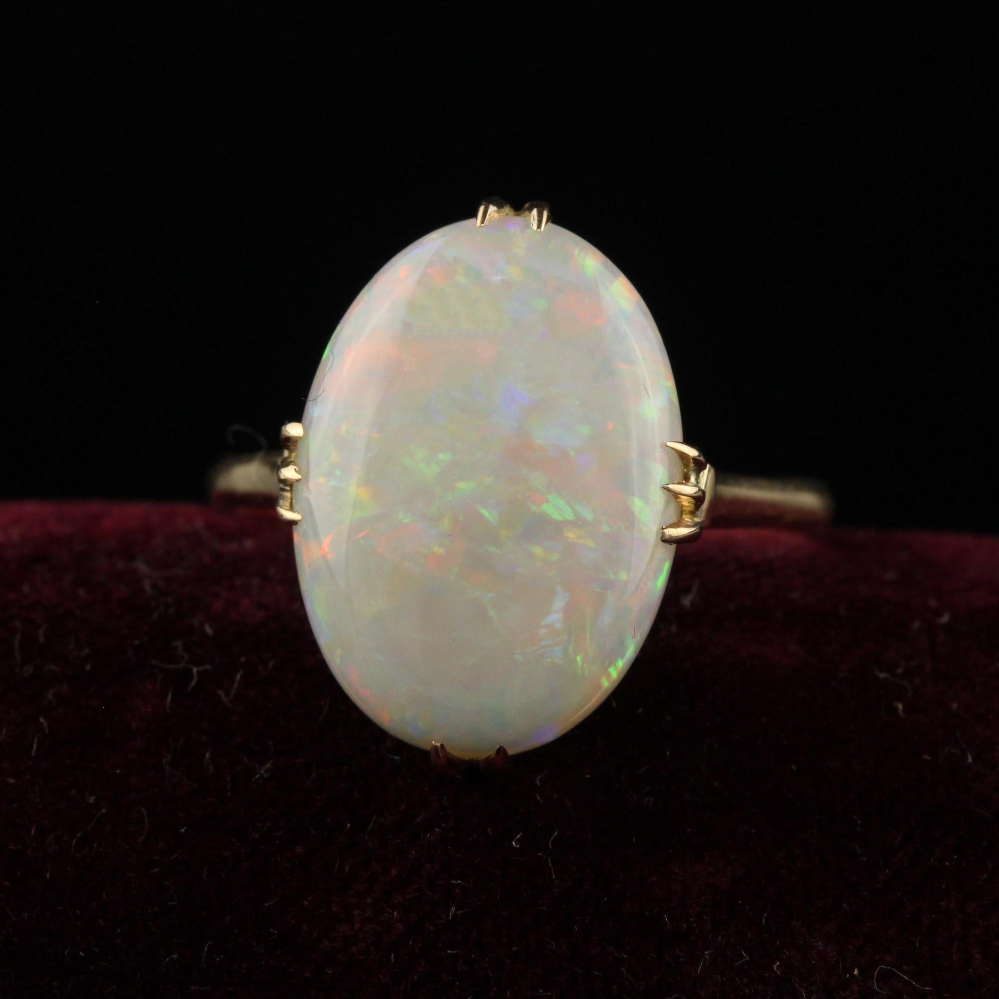 Beautiful Antique Art Deco 18K Yellow Gold Natural Cabochon Opal Filigree Ring. This gorgeous antique art deco opal ring is crafted in 18k yellow gold. The center holds a gorgeous natural opal with a beautiful play of colors. The mounting has