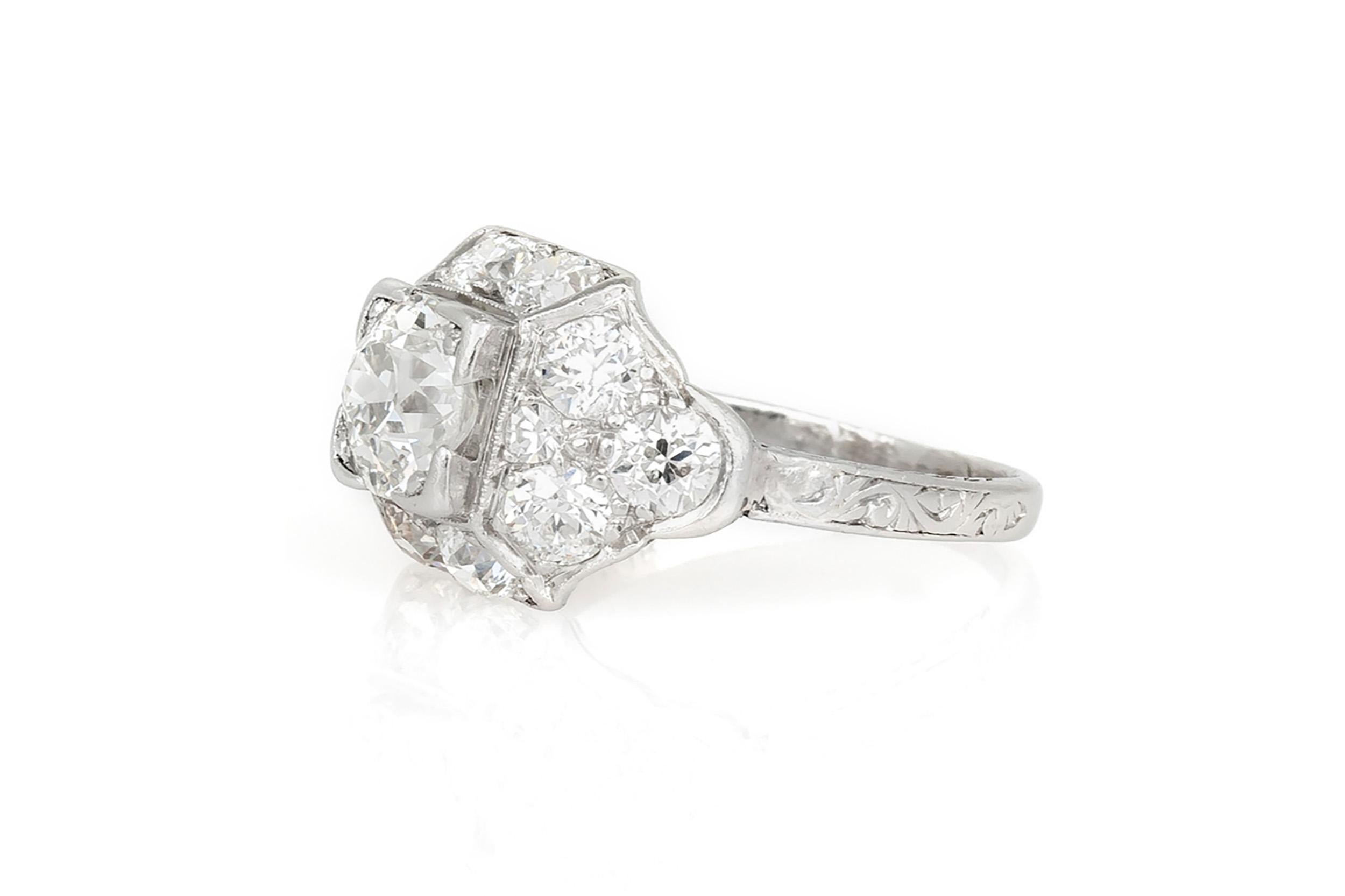 Finely crafted in platinum with an Old European cut Diamond at the center weighing approximately 1.60 carats H color, SI clarity, and 12 accenting Old European cut Diamonds weighing a total of approximately 0.90 carat.
Circa 1915-1920s
Size 4 1/4,