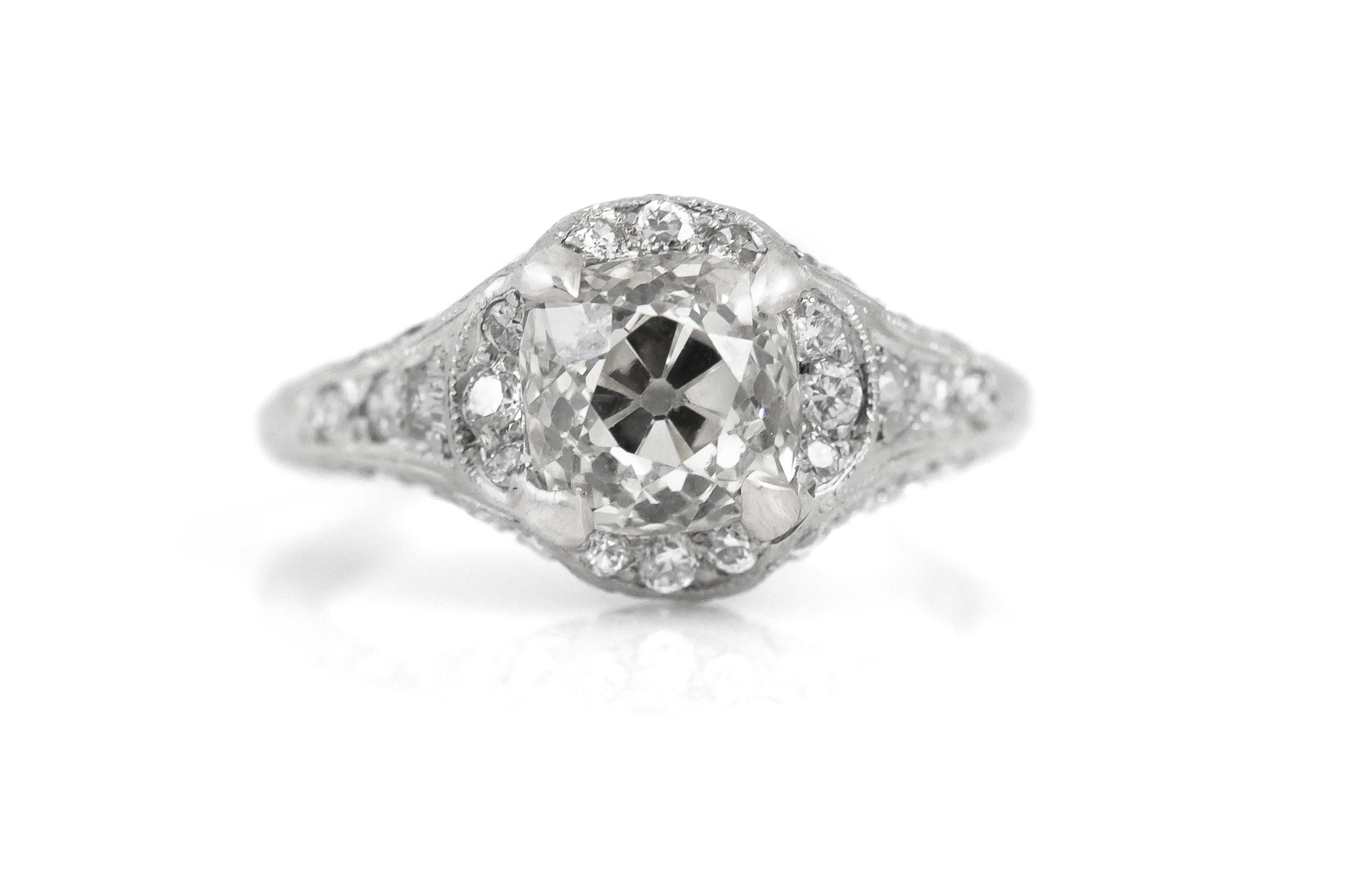 Finely crafted in platinum with an Old Mine cut Diamond at the center weighing approximately 1.75 carats, and small accenting Old European cut Diamonds on the setting weighing a total of approximately 0.90 carats. 
Circa 1920s
Size 5 1/2, resizable