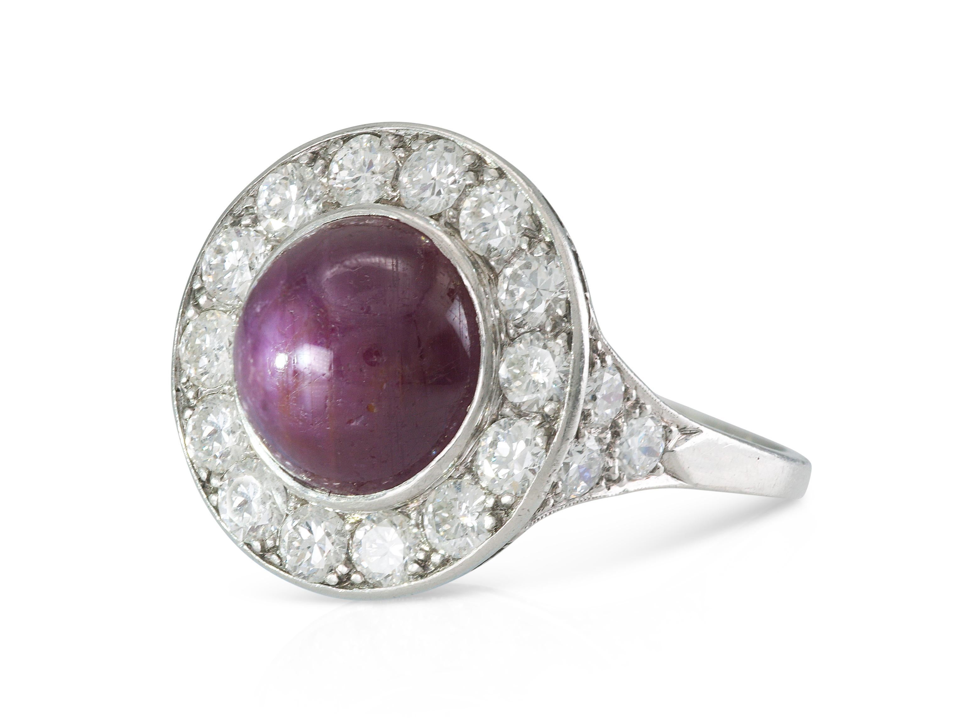 Finely crafted in platinum with a Cabochon Star Ruby weighing approximately 6.00 carats, accented by a halo of Old European cut Diamonds weighing a total of approximately 2.00 carats.
Circa 1920s
Size 8, resizable