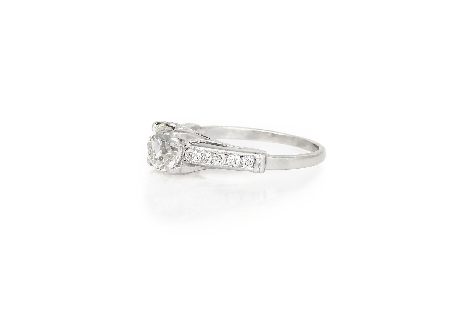 Finely crafted in platinum with an Old Mine cut center Diamond weighing 1.47 carat, J color, VS clarity. 
The ring features 10 additional Diamonds along the setting.
Circa 1930s
Size 7 1/4, resizable