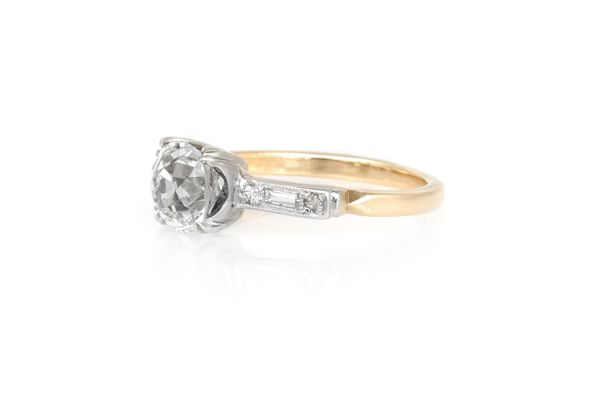 Finely crafted in platinum over 14K yellow gold with an Old Mine cut Diamond weighing 1.67 carats, J color, VS1 clarity.
The ring features accenting Baguette and Round cut Diamonds.   
Circa 1930s
Size 4 3/4, resizable