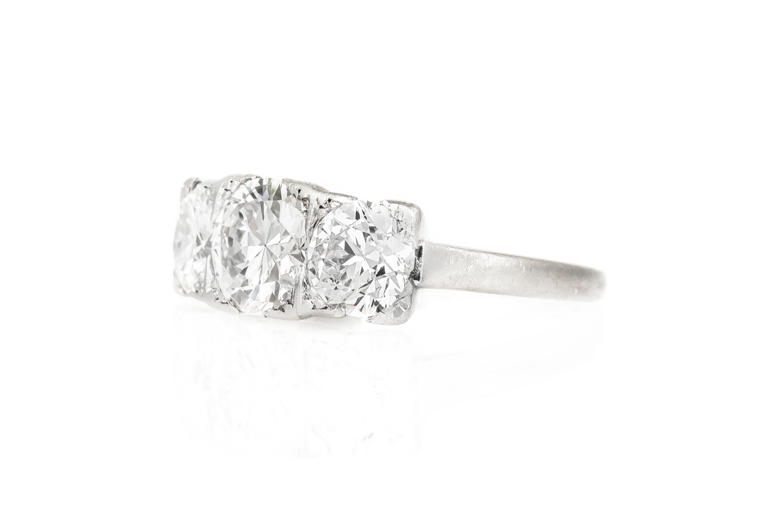 Finely crafted in platinum with an Old European cut Diamond in the center weighing approximately 1.10 carats, G-H color, VS clarity, accented by a pair of Old European cut Diamonds weighing a total of approximately 1.30 carats.  
Circa 1930s
Size 4,