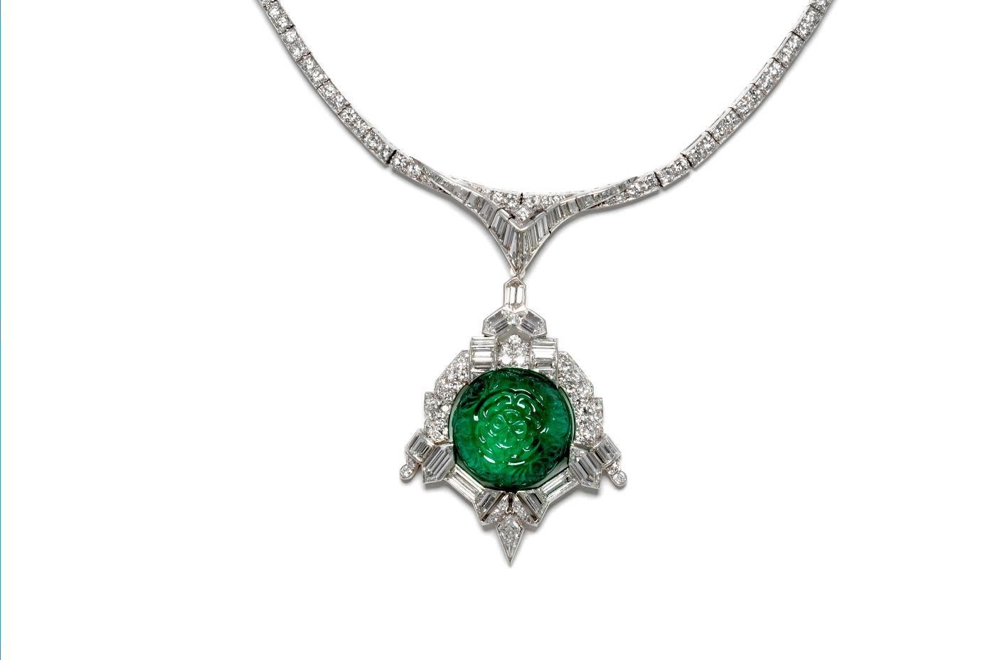 Finely crafted in Platinum with a carved Cabochon Emerald weighing a total of approximately 35.00 carats. The necklace also features Old European, Baguette, Kite, and Trapezoid cut Diamonds weighing a total of approximately 30.00 carats, H-J color,