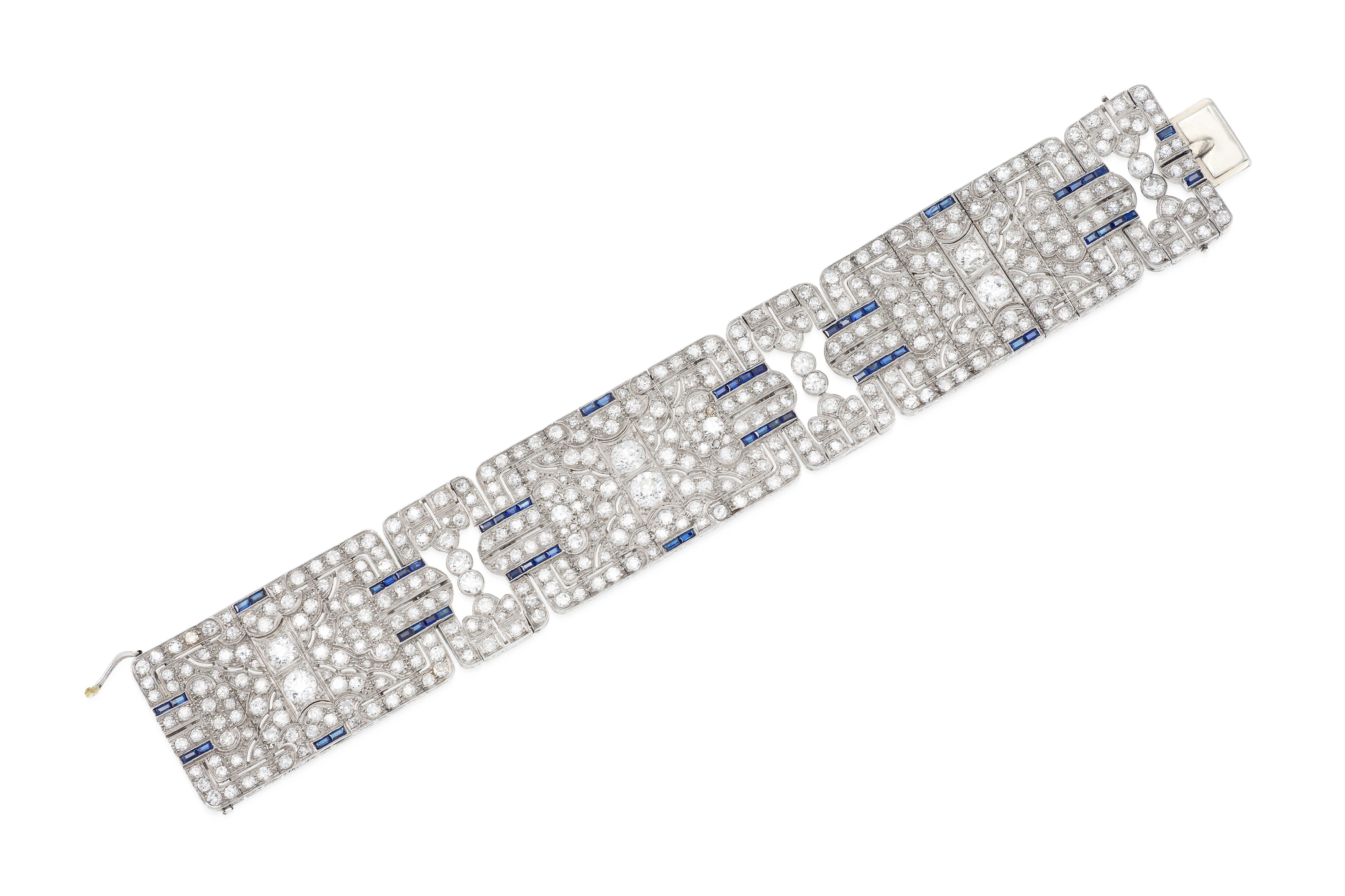 Finely crafted in platinum with 6 large Old European cut Diamonds weighing a total of approximately 4.50 carats and smaller Old European cut Diamonds weighing a total of approximately 35.00 carats. The bracelet features accenting Baguette cut
