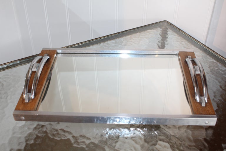 Simple yet very stylish French Art Deco mirrored tray with original mercury glass plate and chrome handles with geometric design. These simple lines are complementary to a 21st century home and would add a bit of soul to a modern interior.
Highly