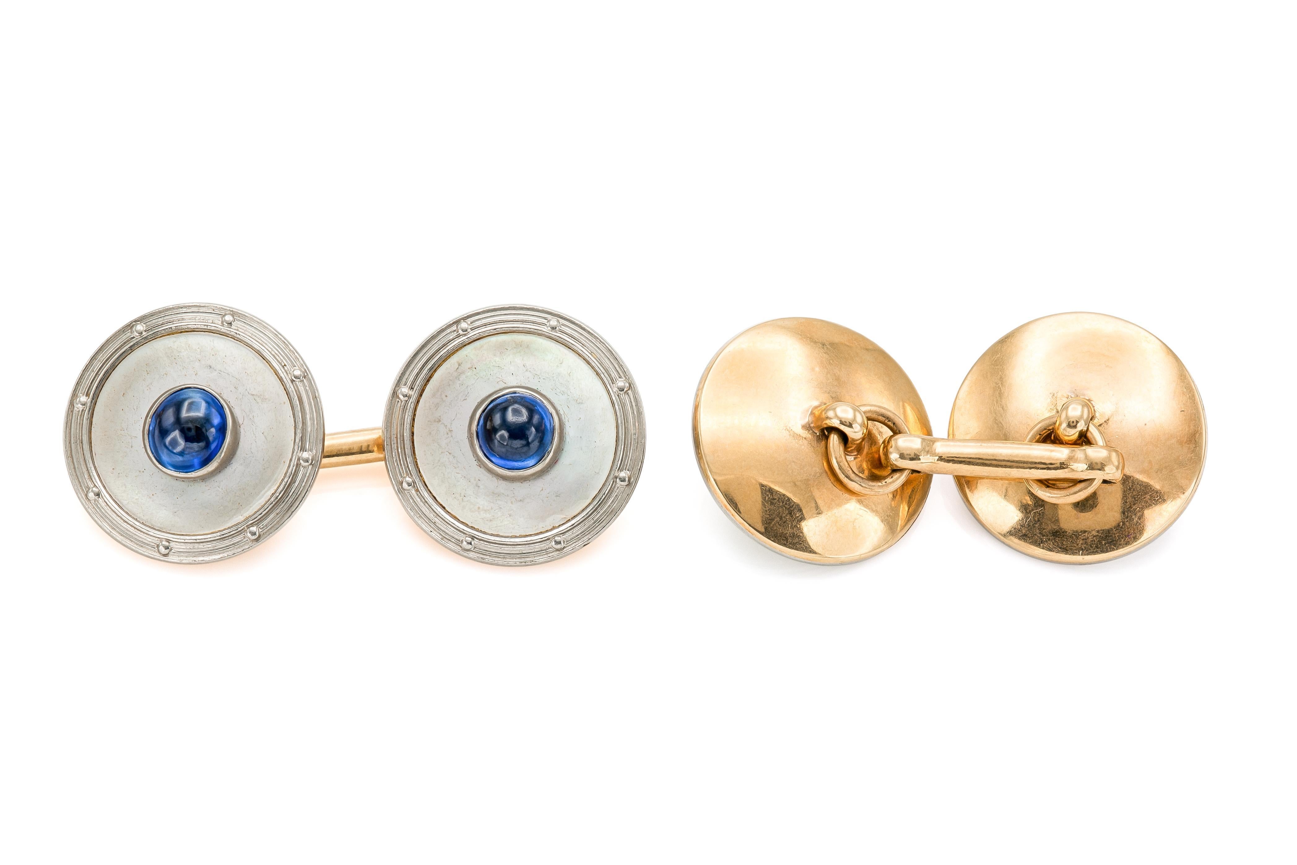 Finely crafted in 14k yellow gold and platinum with Cabochon Sapphires and Mother of Pearl.
The set features cufflinks, 4 large studs, and 3 small studs.
Circa 1930s