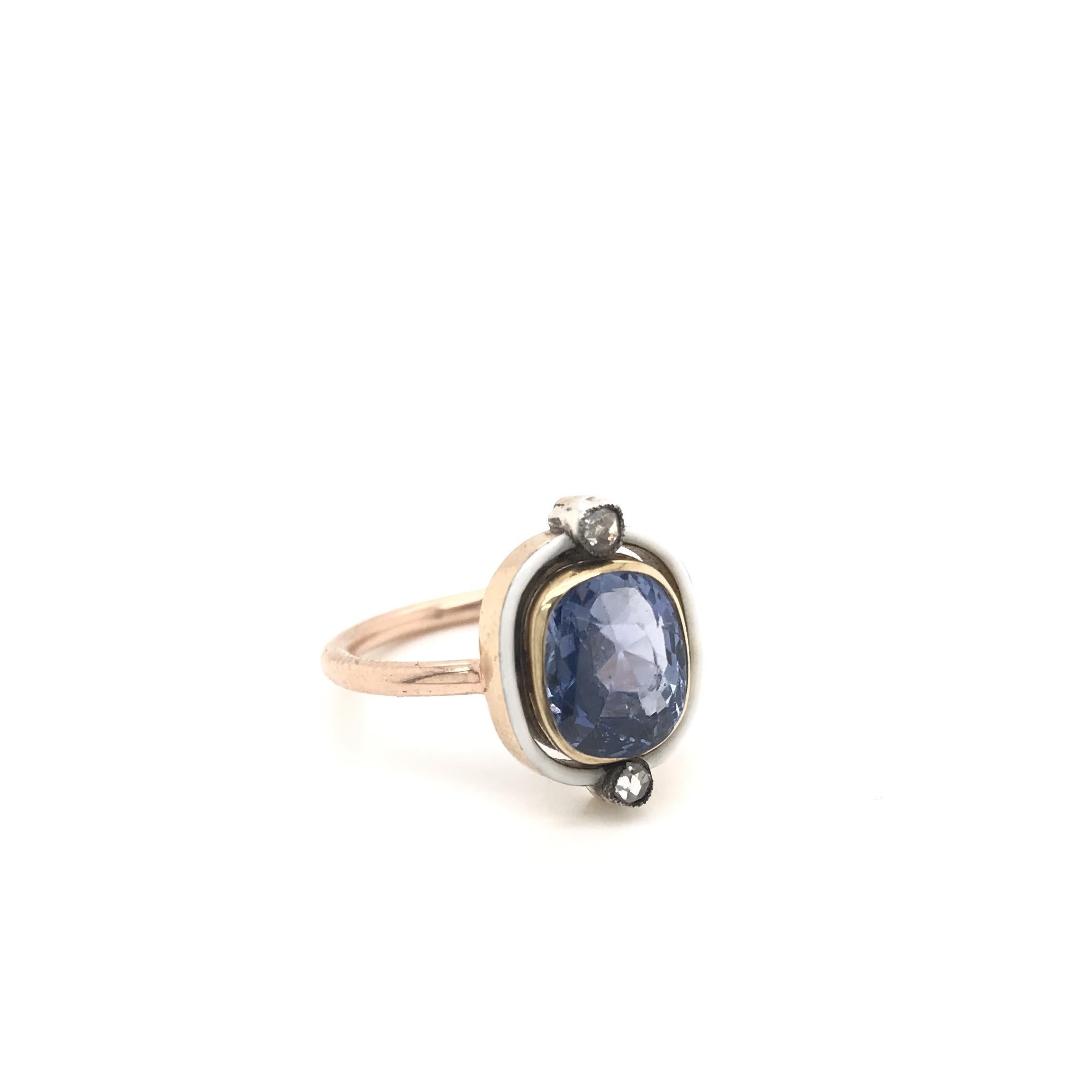 This striking antique piece was crafted sometime during the Art Deco design period (1920-1940). The center stone is a natural blue sapphire measuring approximately 2.50 carats. The sapphire has been certified by The Gemological Institute of America