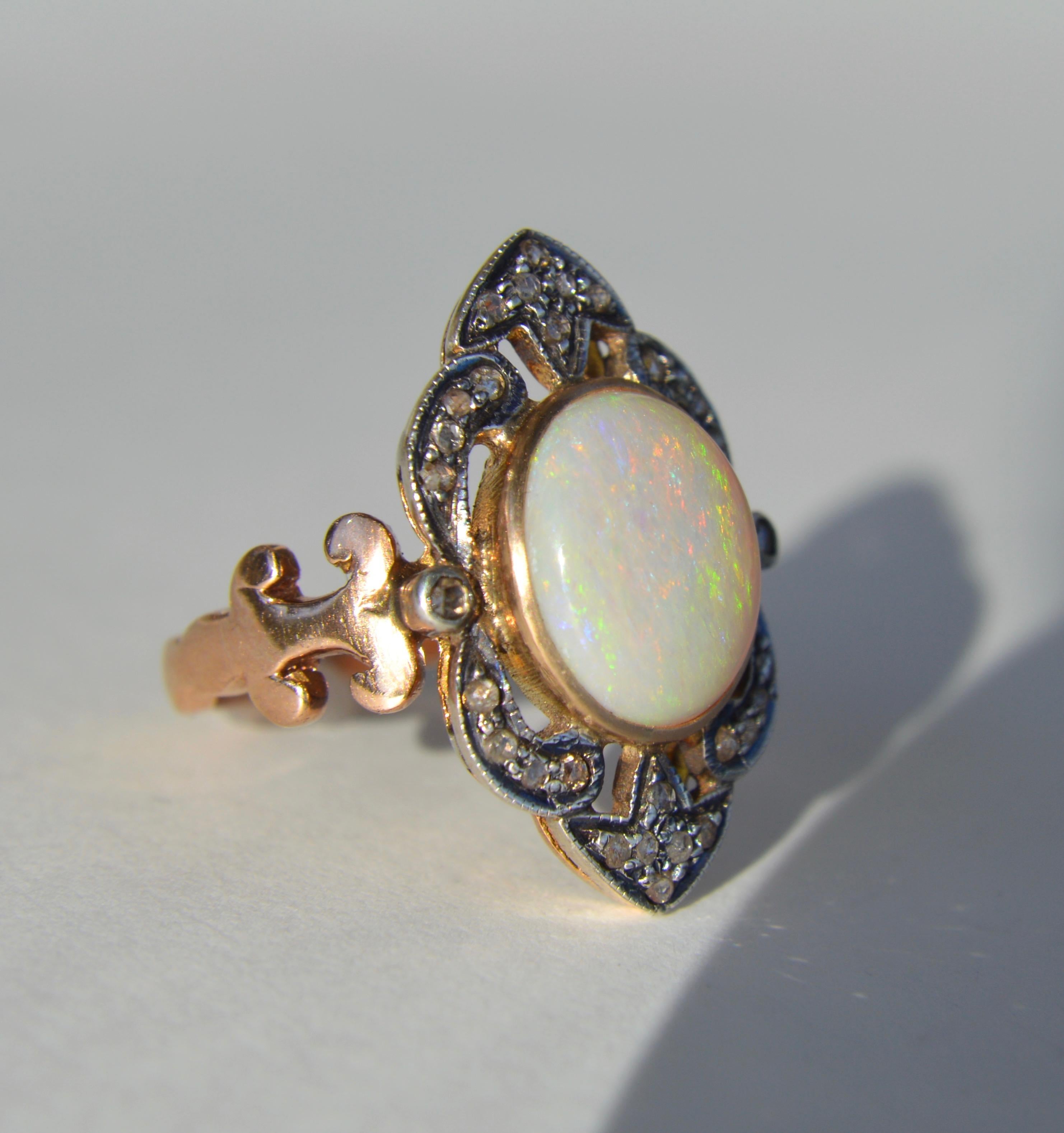 Beautiful antique Art Deco circa 1920s opal and rosecut diamond 10K rose gold cocktail ring. In very good condition, there is a faint line on back of shank where the ring was once resized. Ring is unmarked but tested as solid 10K gold. 

Face of