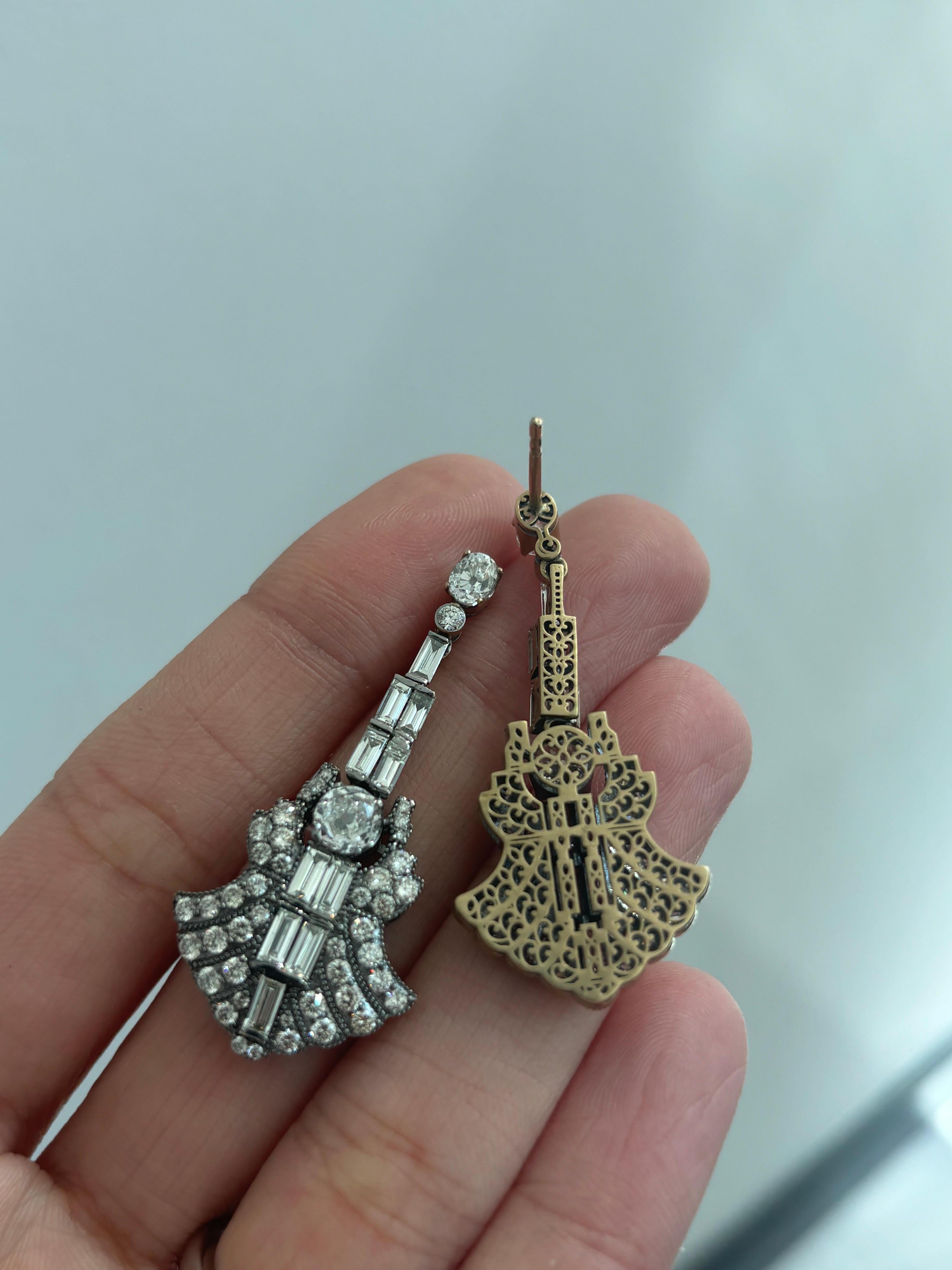 A beautifully hand crafted art-deco looking, 5.30 carat Diamond dangle earrings, set in solid 18K Yellow Gold. The Yellow gold is matte finished, and the earring uses old European cut Diamonds hence giving the earrings an antique look. The earrings
