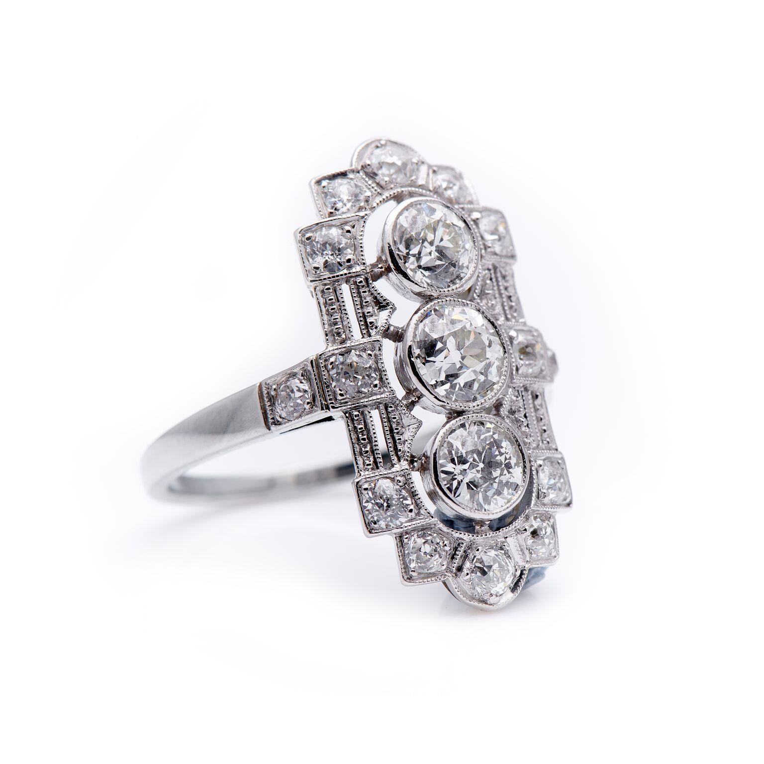 Art Deco, diamond plaque ring, circa 1920. A stunning arrangement of old-cut diamonds, set in white gold, to form this unquestionably Art Deco design. The three principle diamonds are set horizontally to trail and elongate the finger. Further