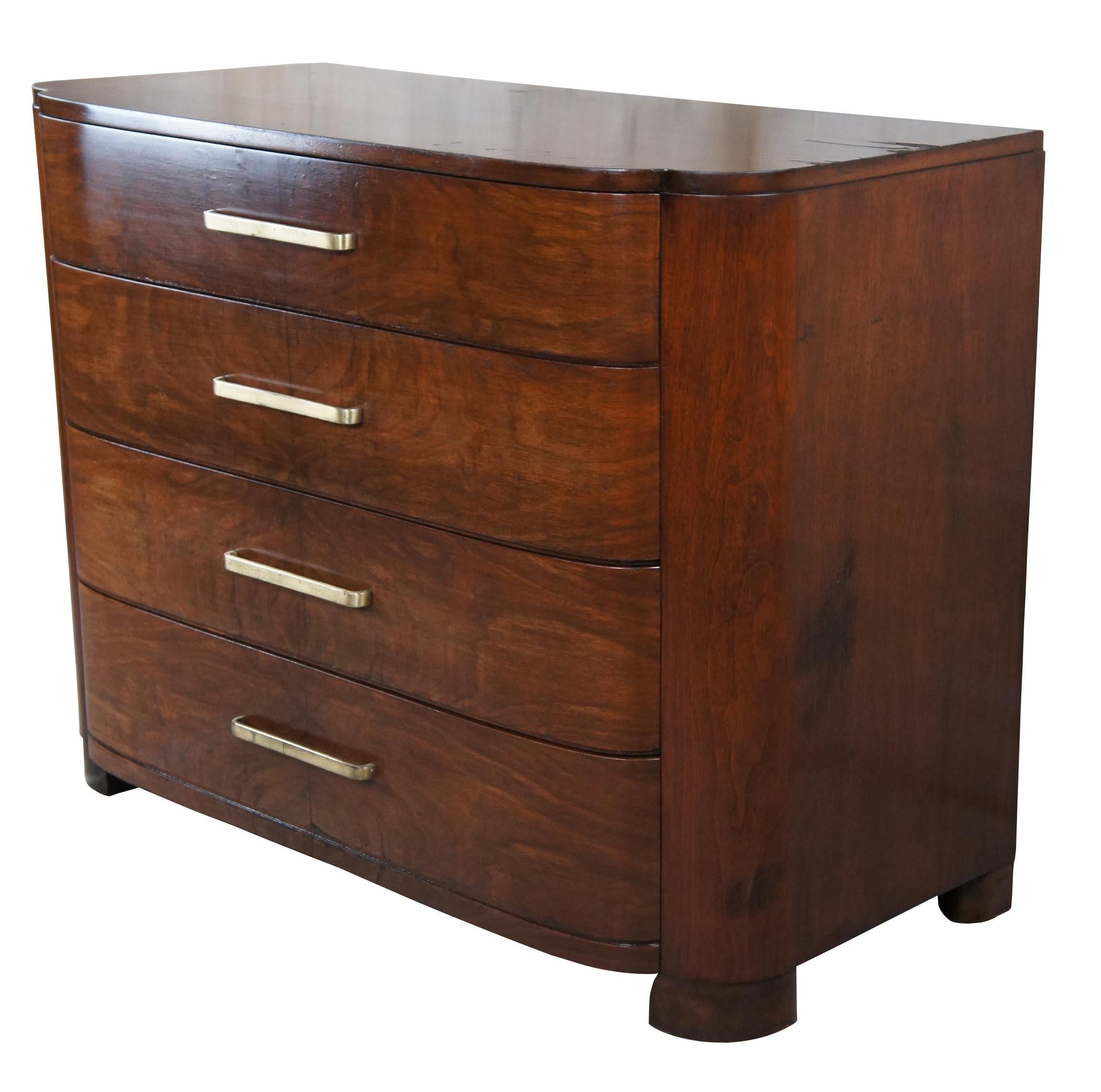 American Late Art Deco nightstand, Circa 1940s. Made from walnut with a contoured front, two dovetailed matchbook walnut drawers and brass hardware. Size: 46