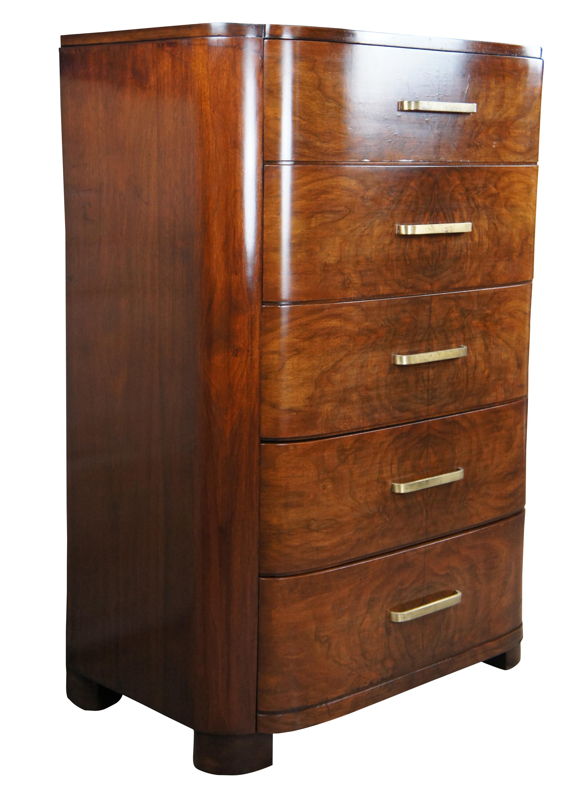 American Late Art Deco tallboy chest of drawers, Circa 1940s. Made from walnut with a contoured front, four dovetailed matchbook walnut drawers and brass hardware. Size:48