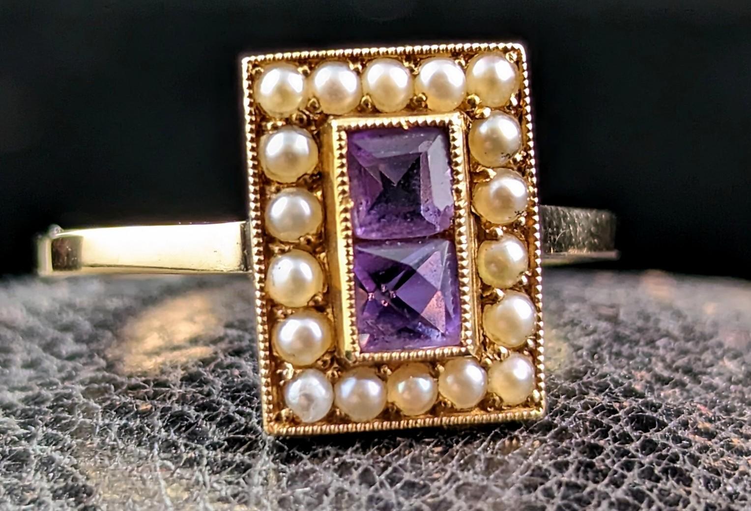 This stunning antique Art Deco era cocktail ring has everything going for it.

Two beautiful rich purple mixed cut Amethyst stones set to the centre, one above the other, surrounded by a halo of pretty creamy seed pearls.

Such a delight and an