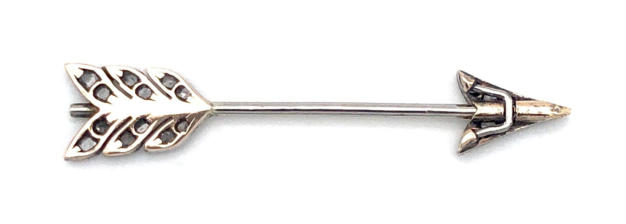 Delightful little jabot pin in the shape of cupids arrow. Arrow head and shaft are set with rose cut diamonds  mounted in platinum backed on gold. This amusing love token can be worn on a lapel, a scarve, a tie or a hat.