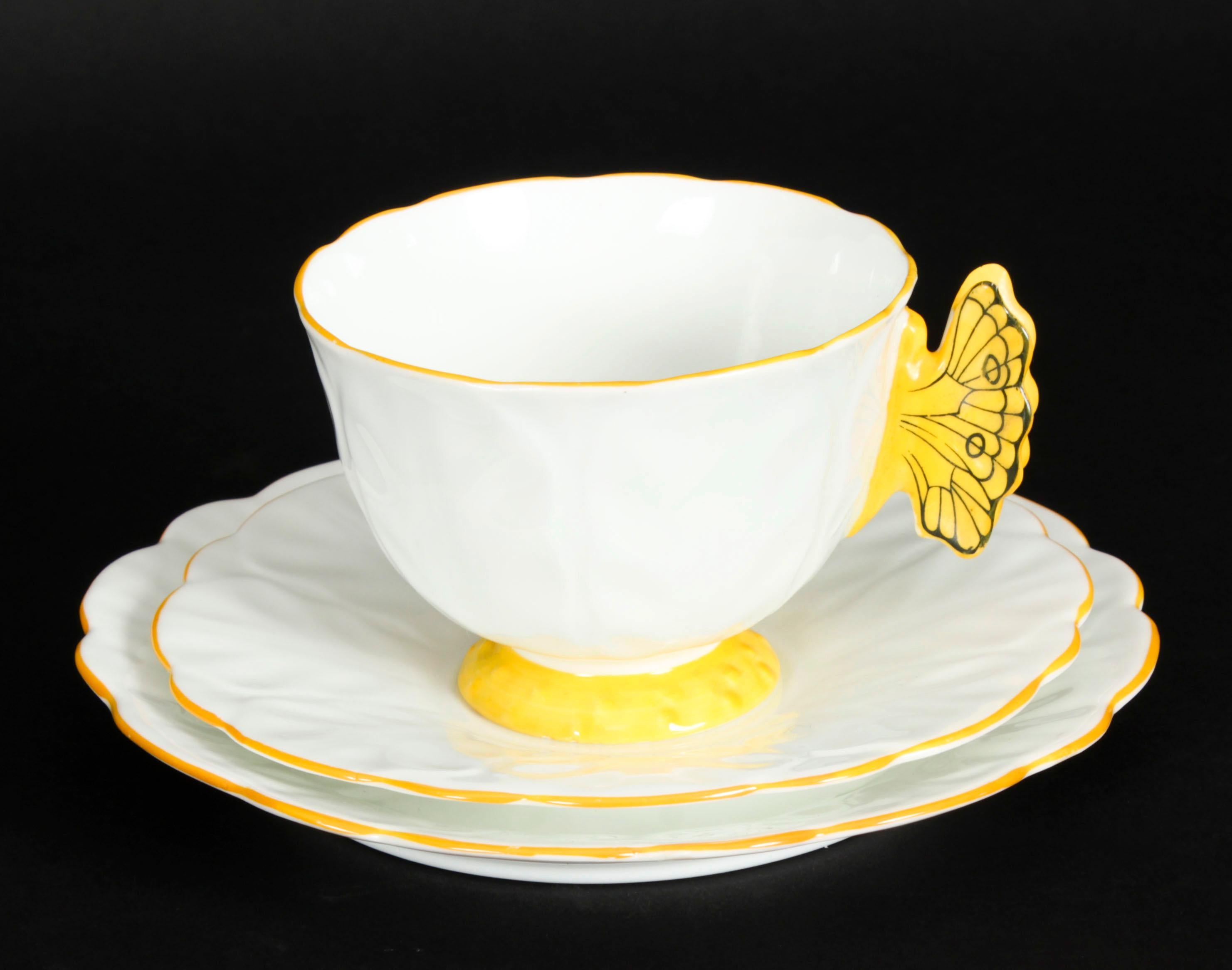 An exquisite, rare, and highly collectible 1920s Tea set with a bright sunshine yellow trim with a butterfly handle.

Aynsley China was a British producer of fine bone china, tableware and commemorative memorabilia, founded in 1775 by John Aynsley