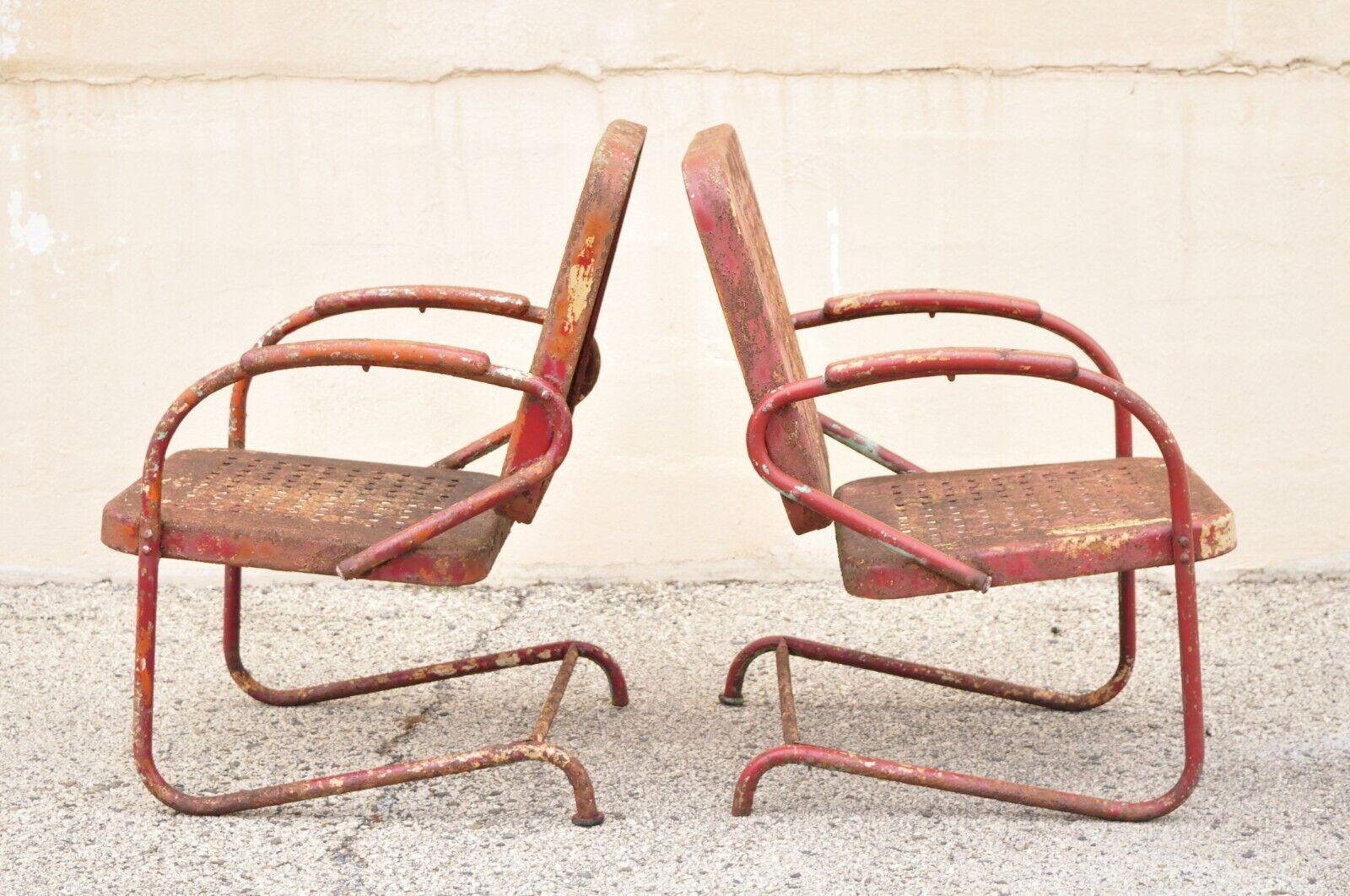 Antique Art Deco basketweave red distress paint bouncer garden chairs - a pair. Item features steel metal bouncer frame, red distress painted finish, basketweave seat and back, very nice antique pair, great style and form. Circa early 20th Century.