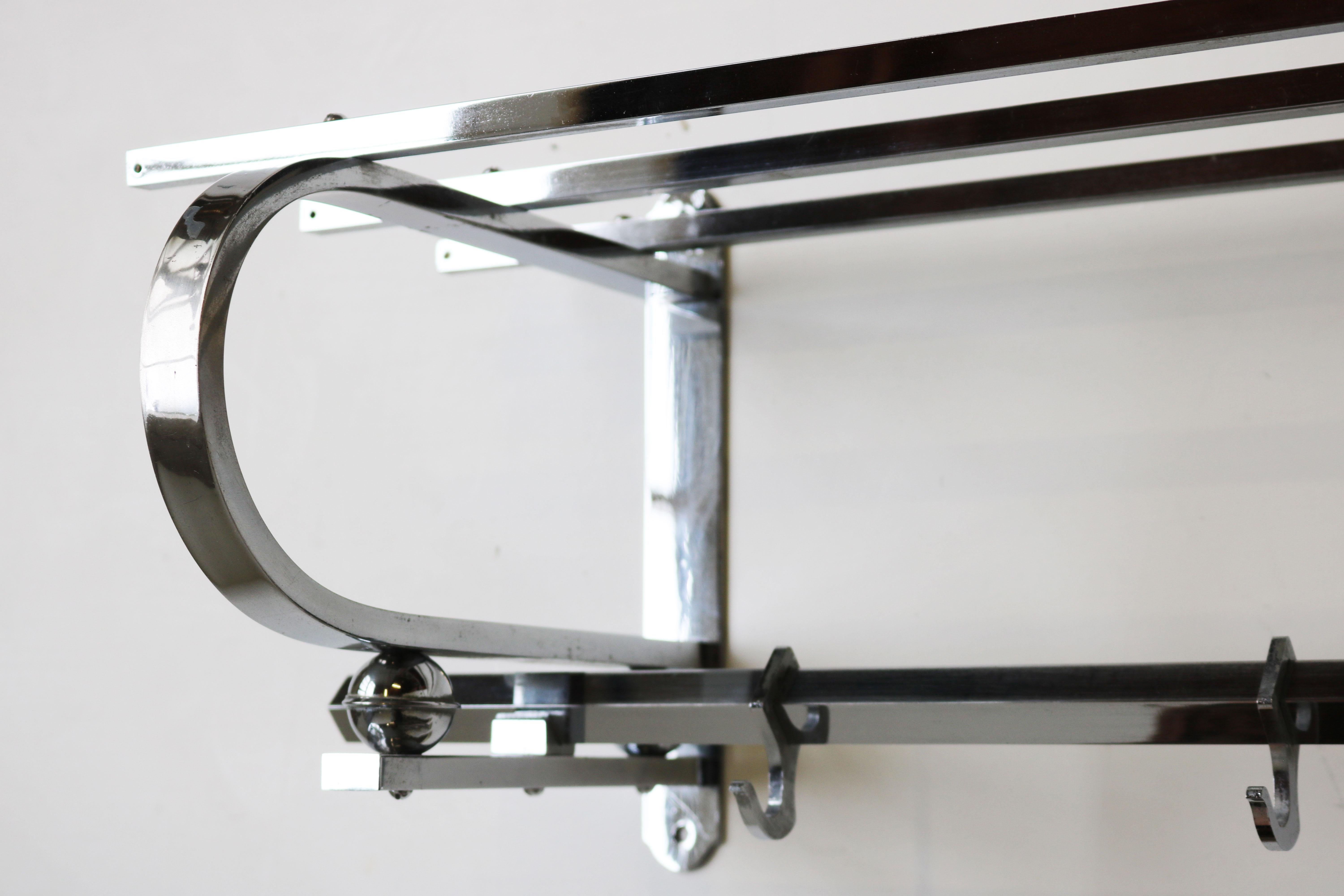 Gorgeous fully original Art Deco Bauhaus coat rack in Chrome from the 1930s. 
Marvelous Art Deco design with the square chrome frame and 4 chrome balls. 
The coat rack has its 8 original hooks and room for hats , very practical for your hallway.