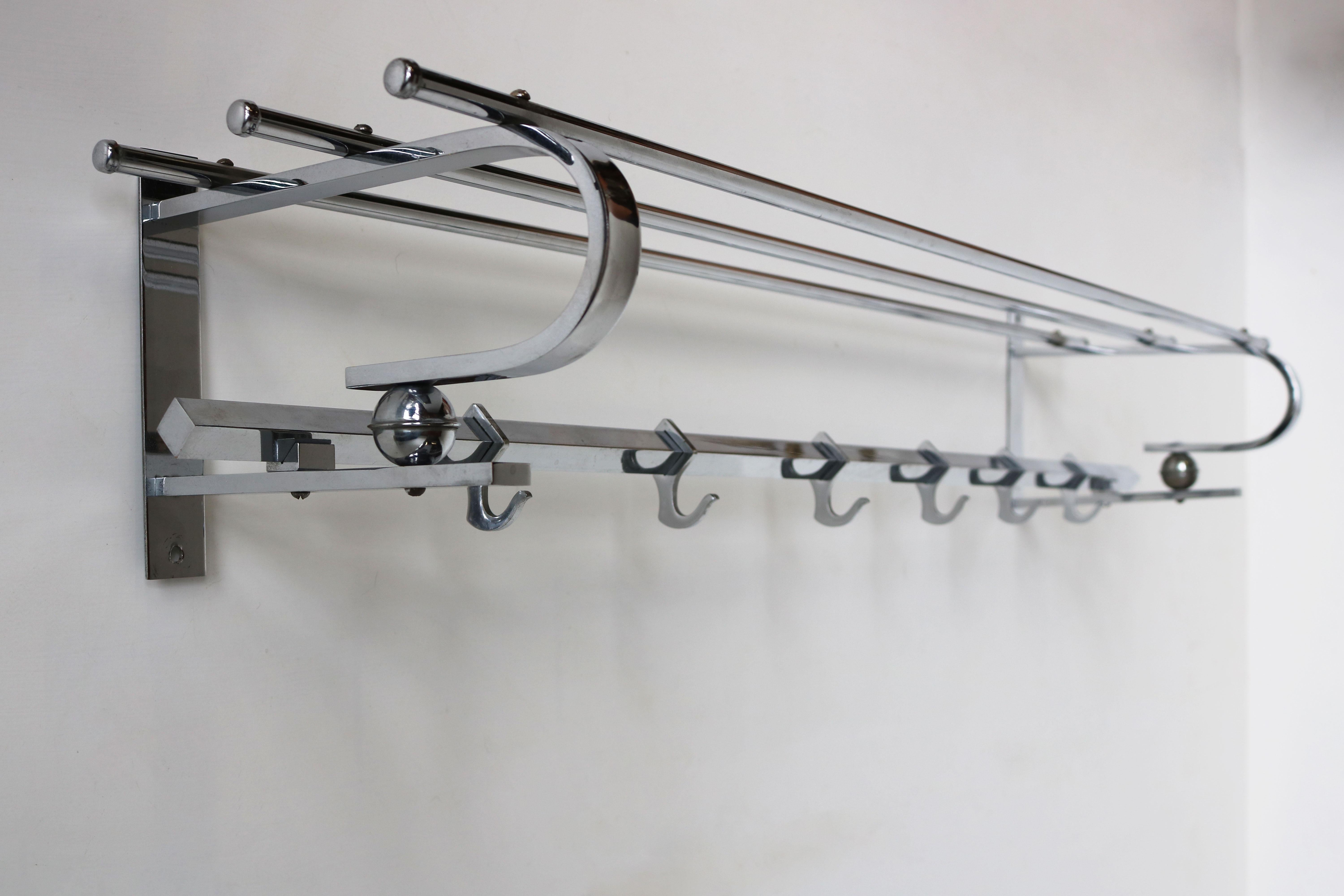 Gorgeous fully original Art Deco Bauhaus coat rack in chrome from the 1930s. 
Marvelous Art Deco design with the square & round chrome frame and 2 chrome balls. 
The coat rack has its 6 original hooks and room for hats , very practical for your
