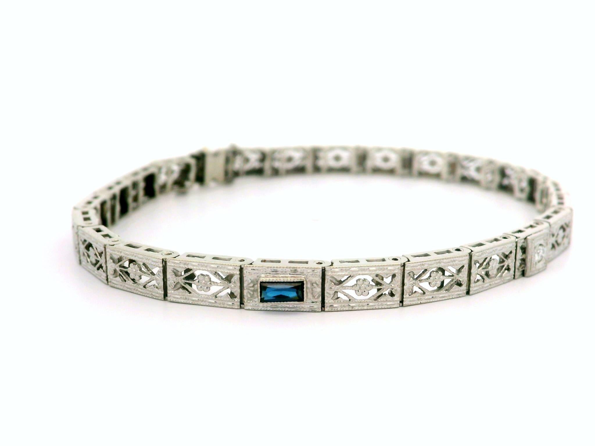–Stone(s)–
(1) Natural Genuine Diamond - Old European Cut - Pave Set - White Color - 0.03ctw (approx.)
(2) Synthetic Sapphire - Rectangular Cut - Milgrain Bezel Set - Deep Blue Color - 3.54mm x 1.74mm (approx.)

Material: 10k White Gold
Weight: 7.17