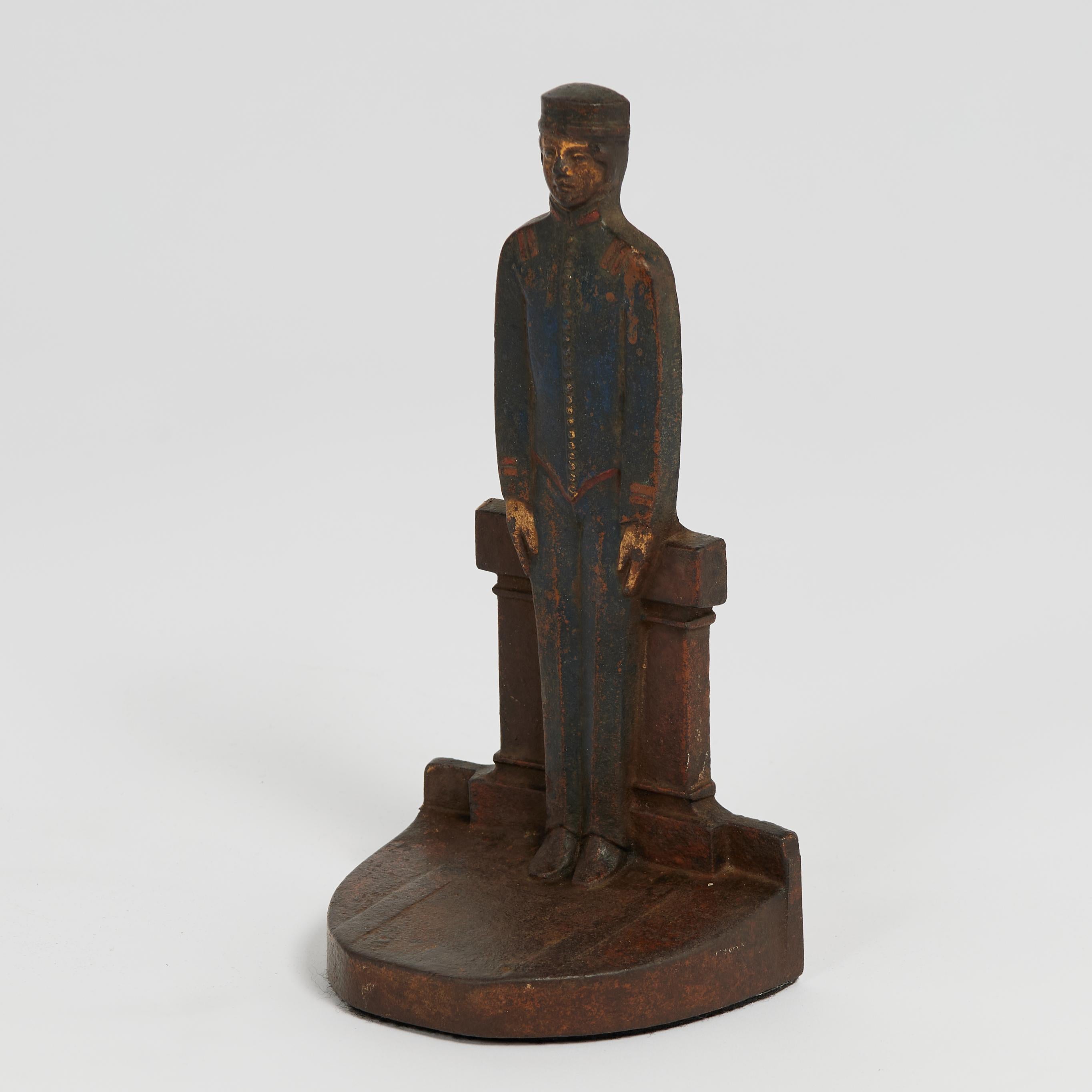 Standout antique cast iron bellhop by C.J.O. Judd, in service as a doorstop with the original paint now worn to perfection.