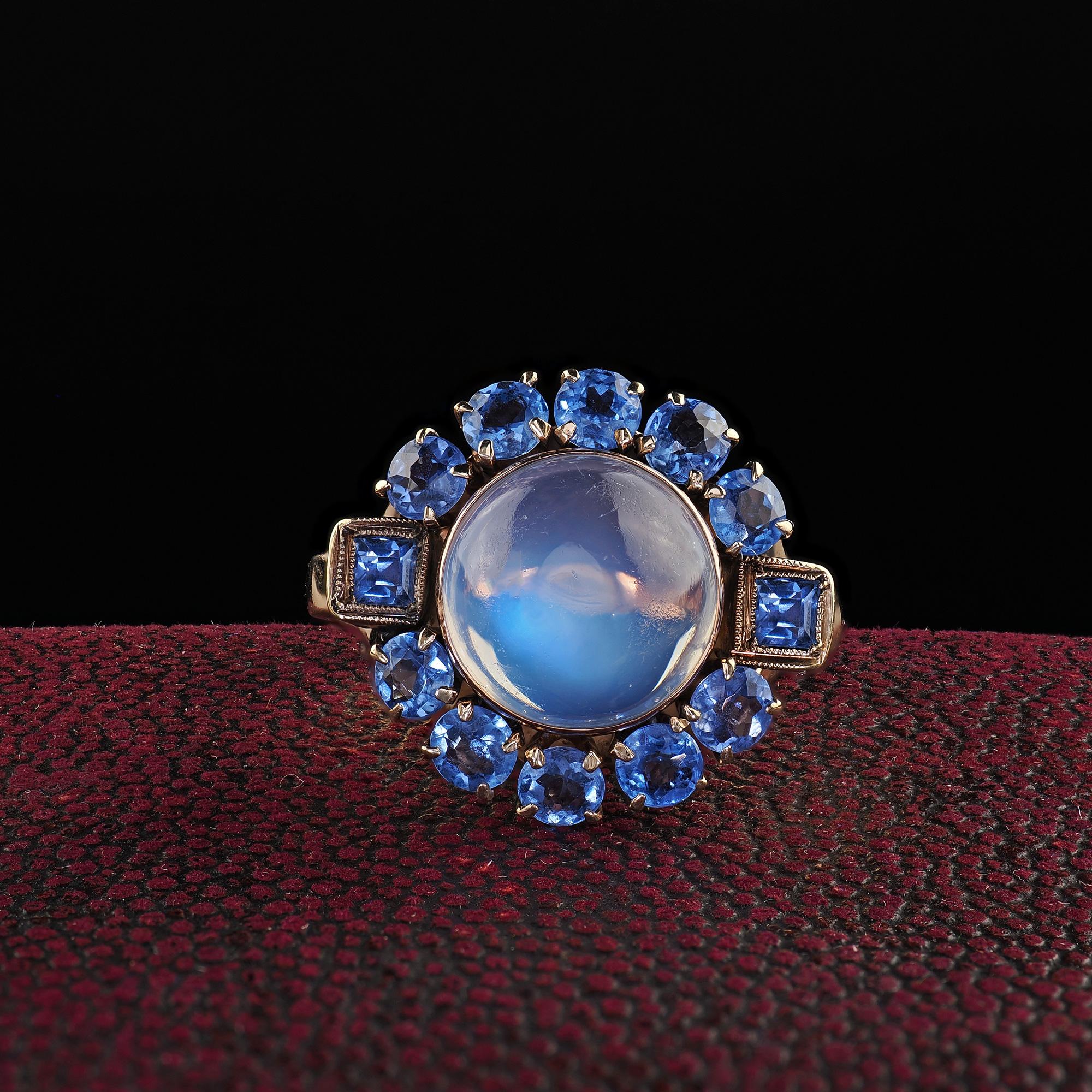 Beautiful Antique Art Deco Binder Bros 14K Rose Gold Cabochon Moonstone Yogo Sapphire Ring. This gorgeous Art Deco Binder Bros moonstone and Yogo Gulch sapphire ring is crafted in 14k rose gold. This ring features a beautiful moonstone in the center