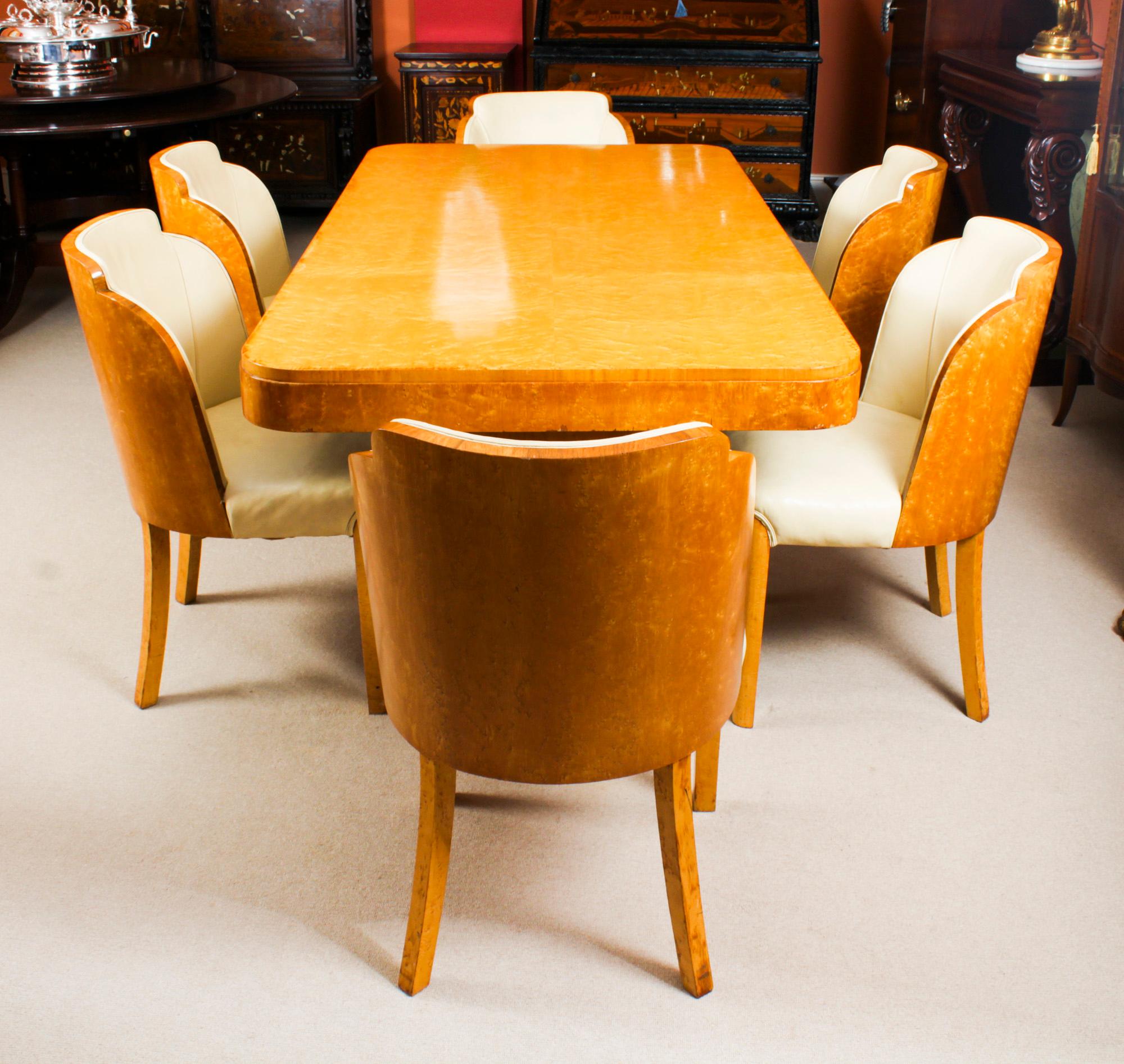 A truly stunning antique Art Deco birds-eye maple dining suite attributed to the world renowned cabinet makers, Harry & Lou Epstein, comprising a dining table and the original matching set of six cloud back dining chairs, circa 1920 in date.

The
