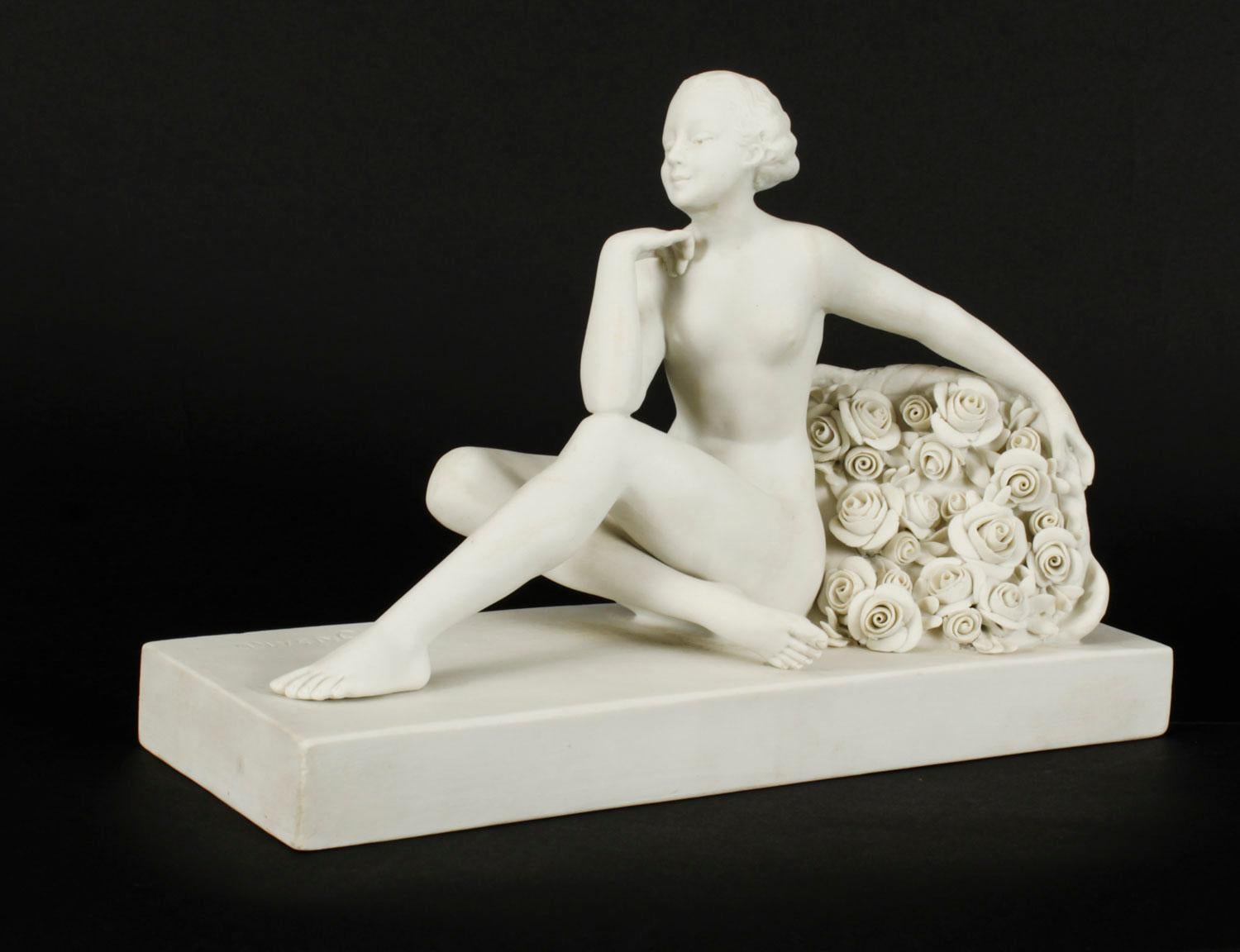 This is a magnificent antique French Art Deco bisque porcelain model of a seated nude woman with flowers by the sculptor Henri Desire Grisard (1872-active until 1940) and bearing his signature and the impressed mark 