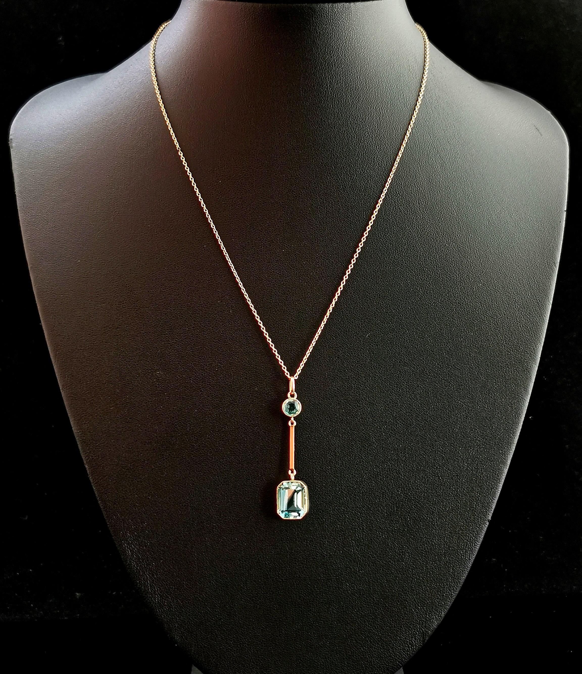 A beautiful Antique Art Deco 9kt Rose gold and blue Zircon drop pendant.

The pendant has a round cut blue Zircon to the top beneath the bale which is intercepted by a rose gold bar drop, from here there is a beautiful emerald cut blue Zircon which