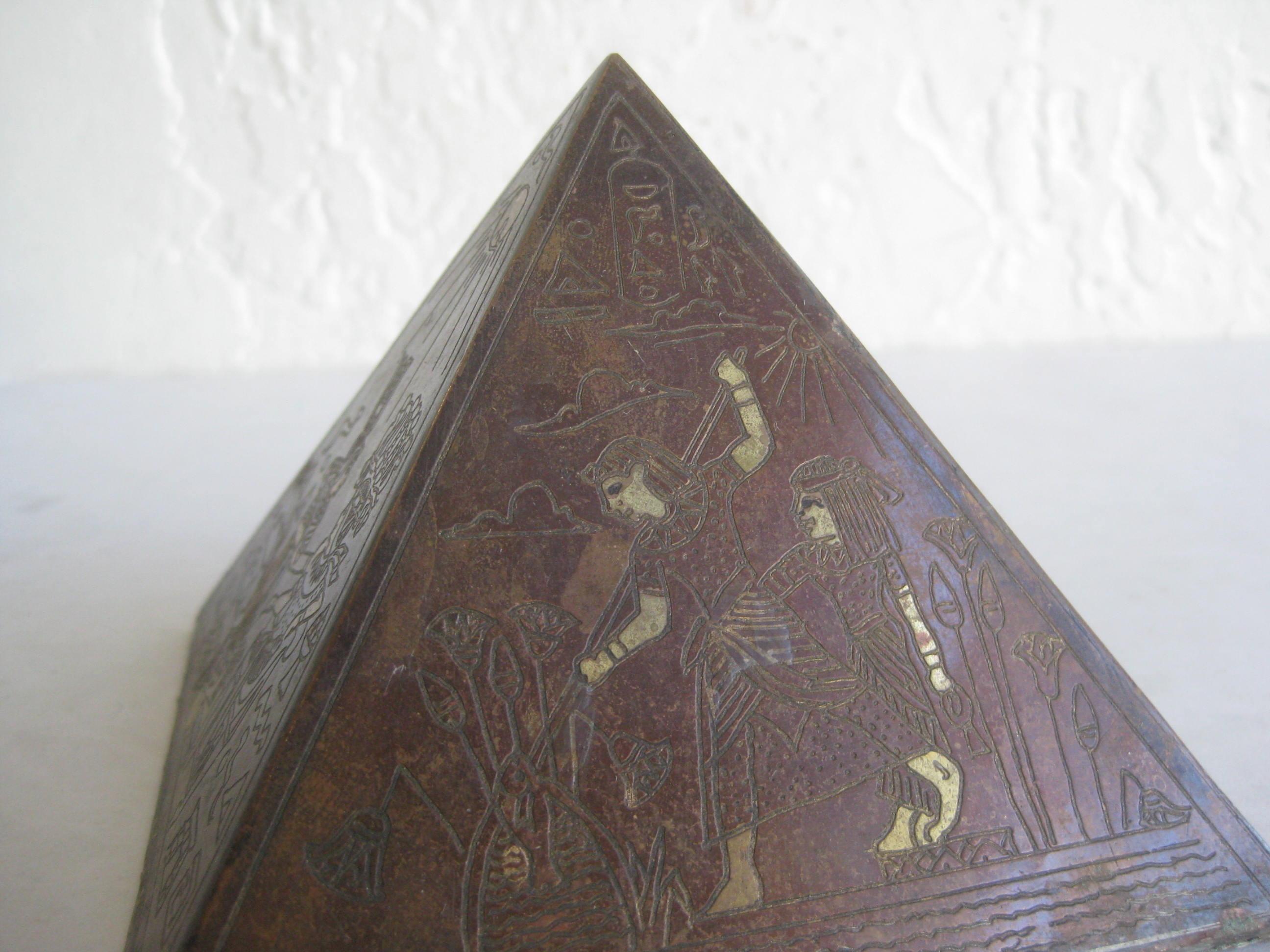 Unique antique Art Deco Egyptian Revival pyramid desk paperweight/statue. Made of brass and copper. Great etched decorations on the four sides. Patina is nice and dark and can be polished if desired. Each side has a different scene. Filled with sand