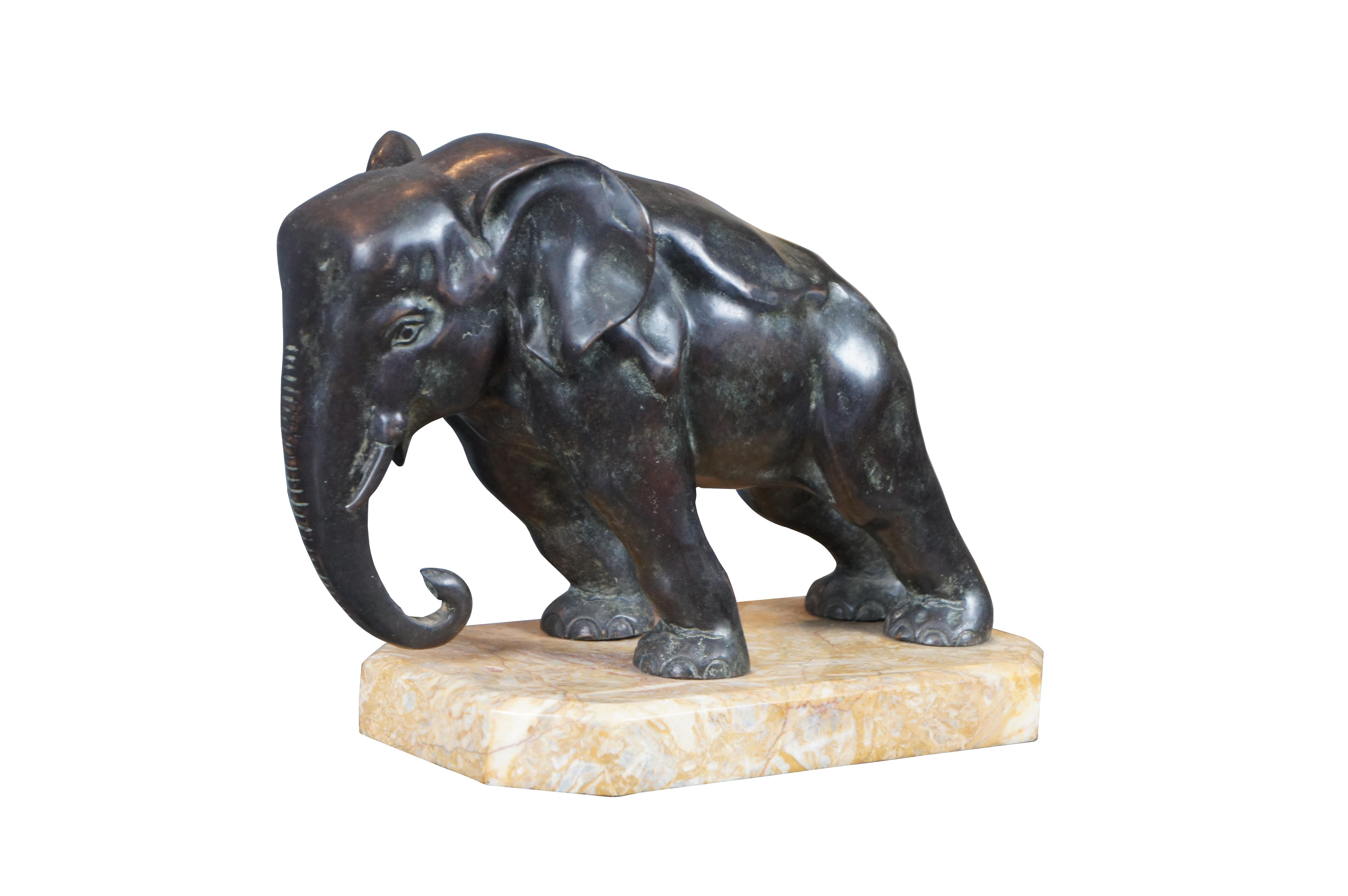 Art Deco bronze bookend, circa 1920s. An uncommon large size, depicting an elephant leaning forward bracing to hold up a row of books.

Pushing with the flattened front part of its head, trunk are partially curled beneath open mouth with short