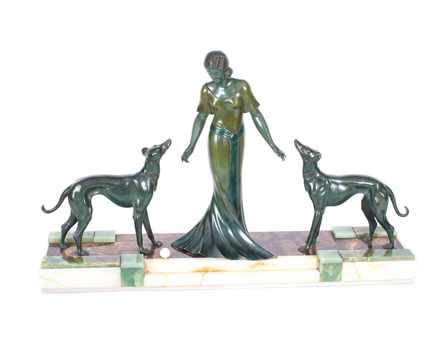 This is a magnificent large antique French Art Deco bronze sculpture of a maiden and two hounds, by the sculptor P. Huguenot, bearing his signature and circa 1920 in date.
 
This stunning sculpture features the remarkable central figure of a maiden