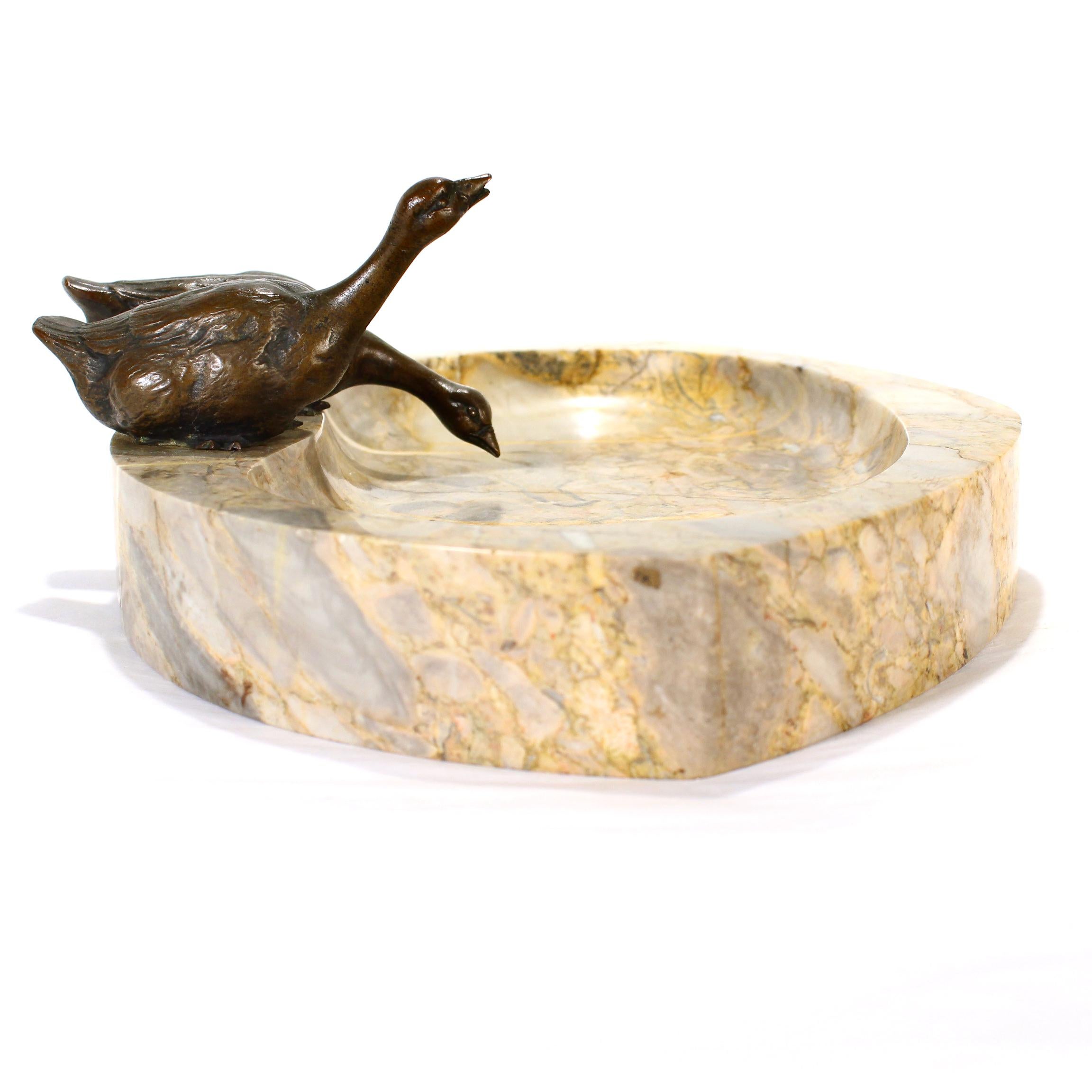 A fine antique vide poche.

Comprising a mottled caramel-colored marble base (or bowl) with mounted with two bronze geese to the top. 

Incised 'Germany' to the underside. 

Simply a wonderful Continental Art Deco piece!

Date:
Early 20th