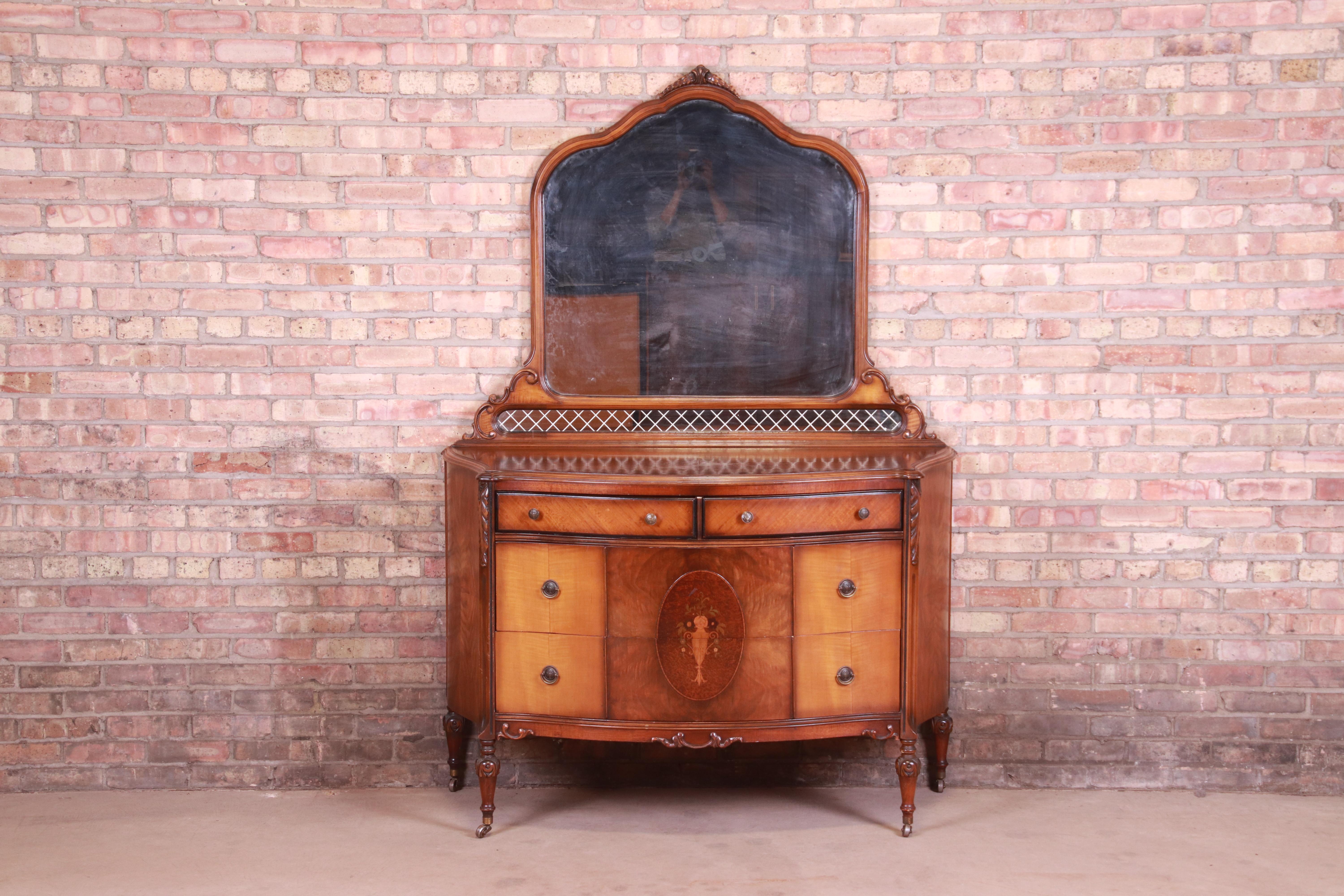 A gorgeous antique French Art Deco four-drawer dresser with mirror

In the manner of Widdicomb

USA, circa 1920s

Burled walnut and satinwood, with inlaid floral marquetry, original brass hardware, and mirror.

Measures: 52