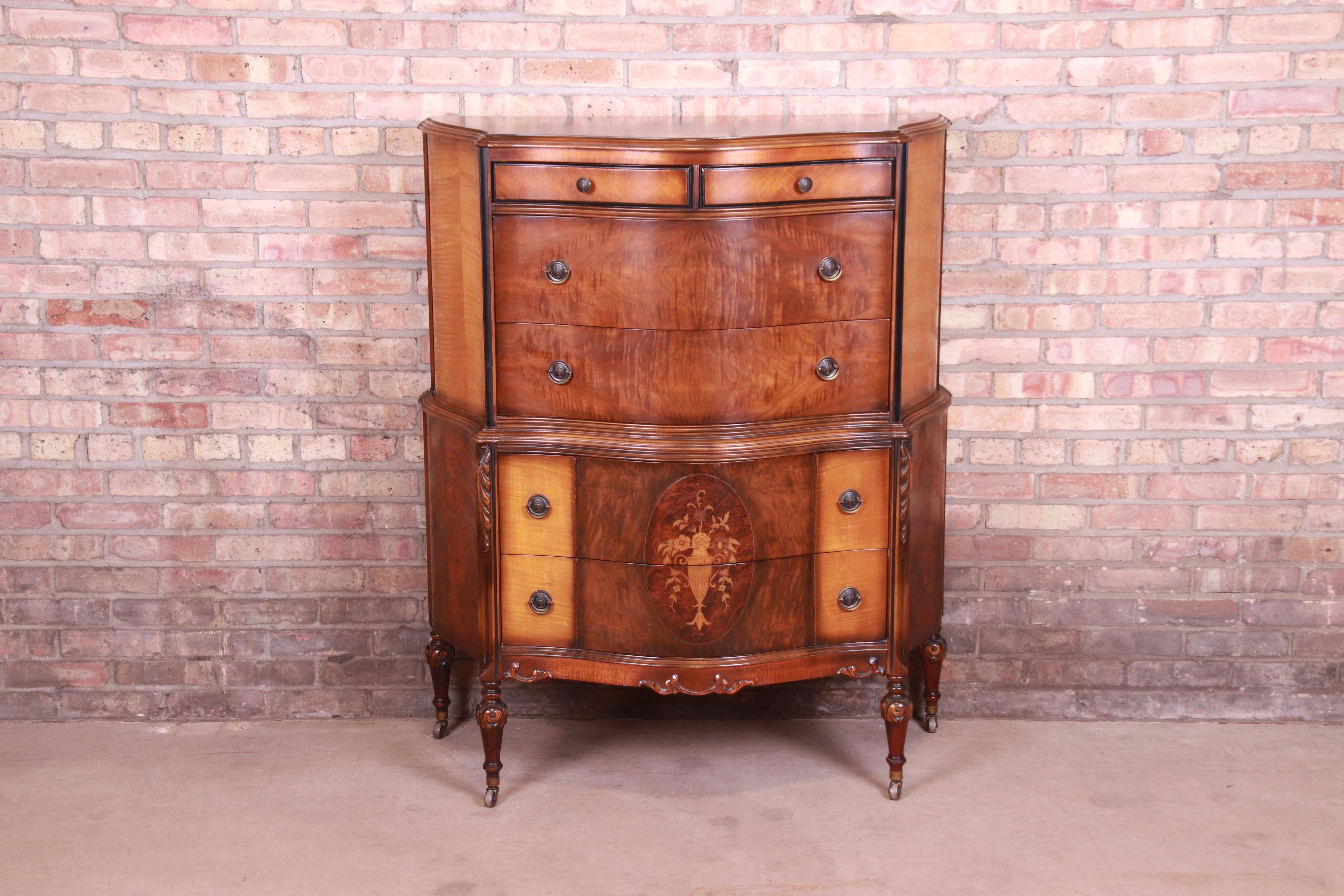 A gorgeous antique Art Deco six-drawer highboy dresser

In the manner of Widdicomb,

USA, Circa 1920s

Burled walnut and satinwood, with inlaid floral marquetry and original brass hardware.

Measures: 41