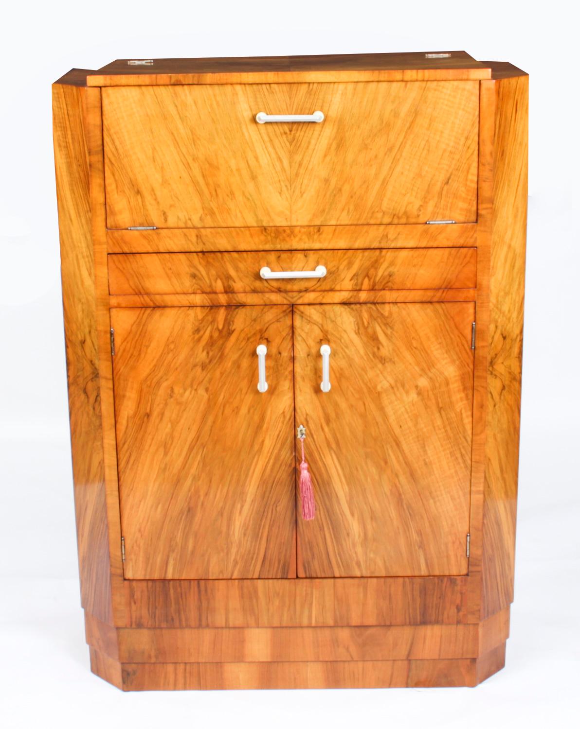 This is a fantastic antique Art Deco burr walnut cocktail cabinet, circa 1920 in date. 

It is of rectangular form, made in beautiful burr walnut, the upper part opens to reveal a fitted mirrored interior with bottle and decanter racks. 

Below