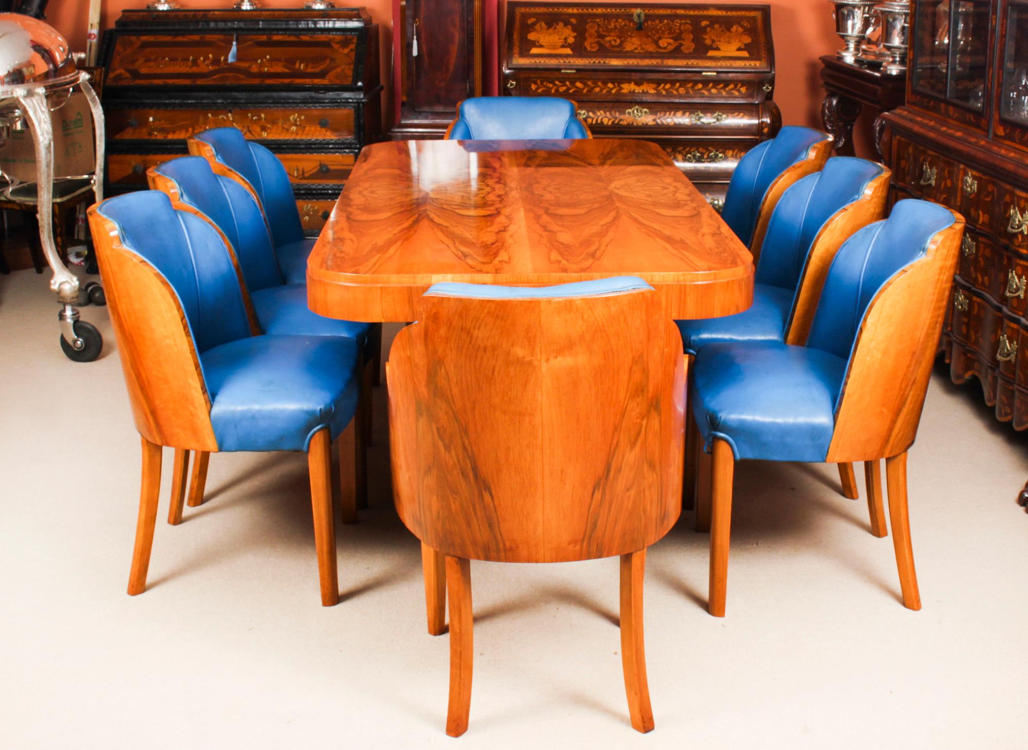 A truly stunning antique Art Deco burr walnut dining suite attributed to the world renowned cabinet makers, Harry & Lou Epstein, comprising a dining table and the original matching set of eight cloud back dining chairs, circa 1920 in date.
 
The