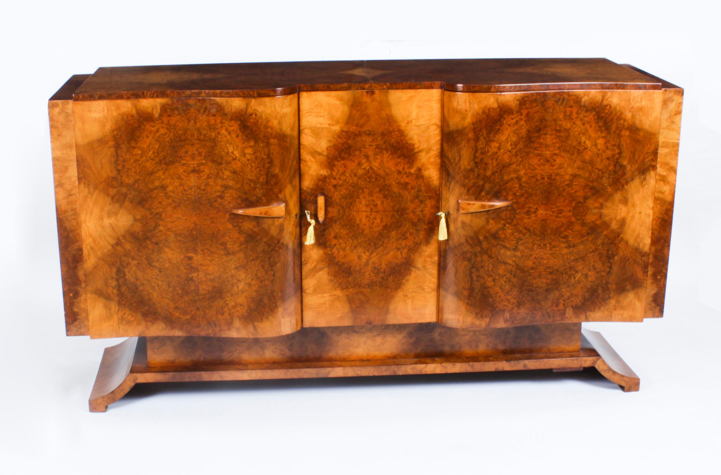 This is an elegant and very fine Art Deco sideboard of the very highest quality, in fabulous burr walnut, by Salaman Hille for S Hille Co. Ltd, circa 1920 in date.
 
The sideboard has a shaped top, an exaggerated serpentine form and it features