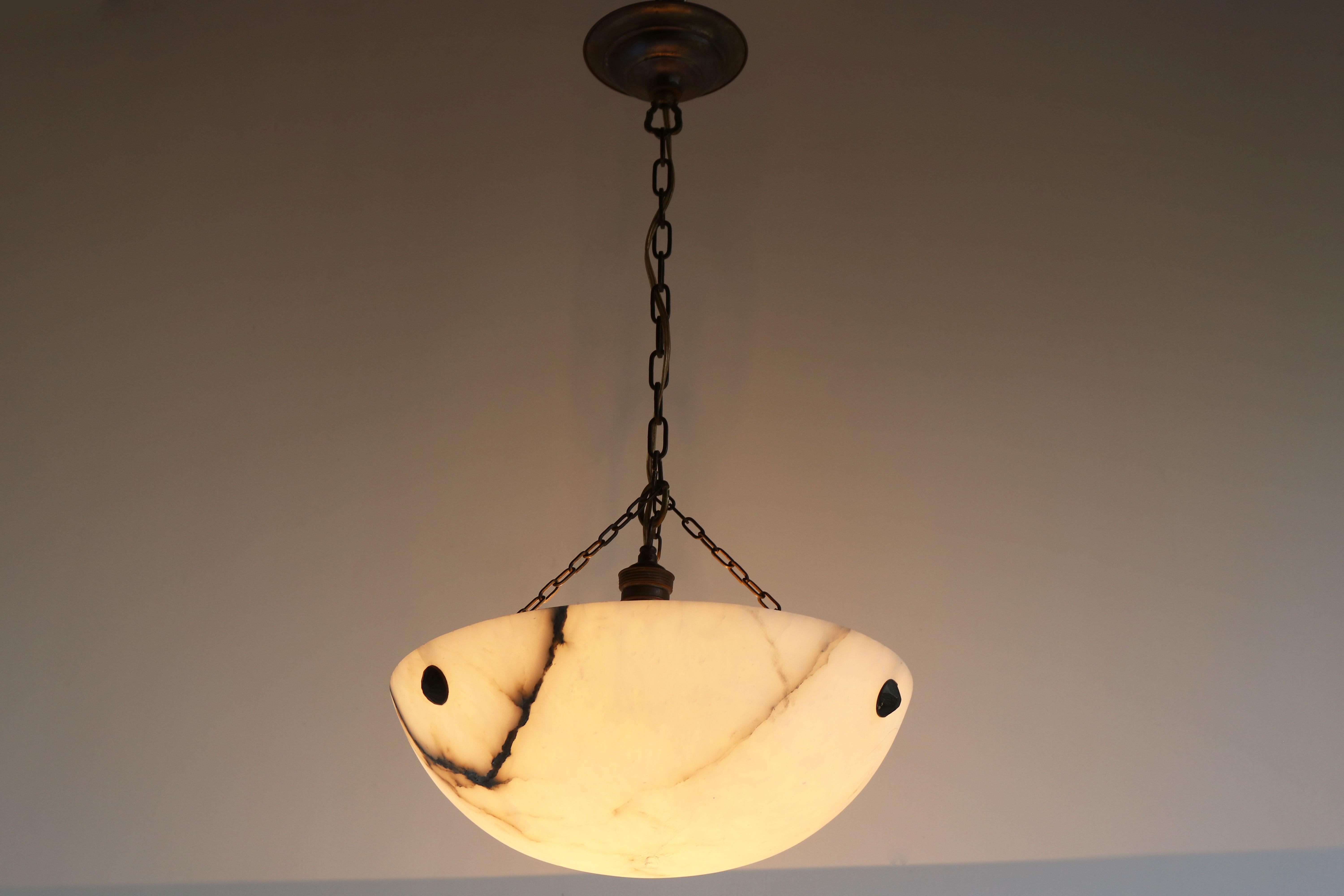 Gorgeous & stylish! this antique Art Deco carved Alabaster pendant / chandelier with black veins 1920. The light has its original brass suspension & canopy. The natural stone looks amazing when lit, these alabaster shades always impress. Superb